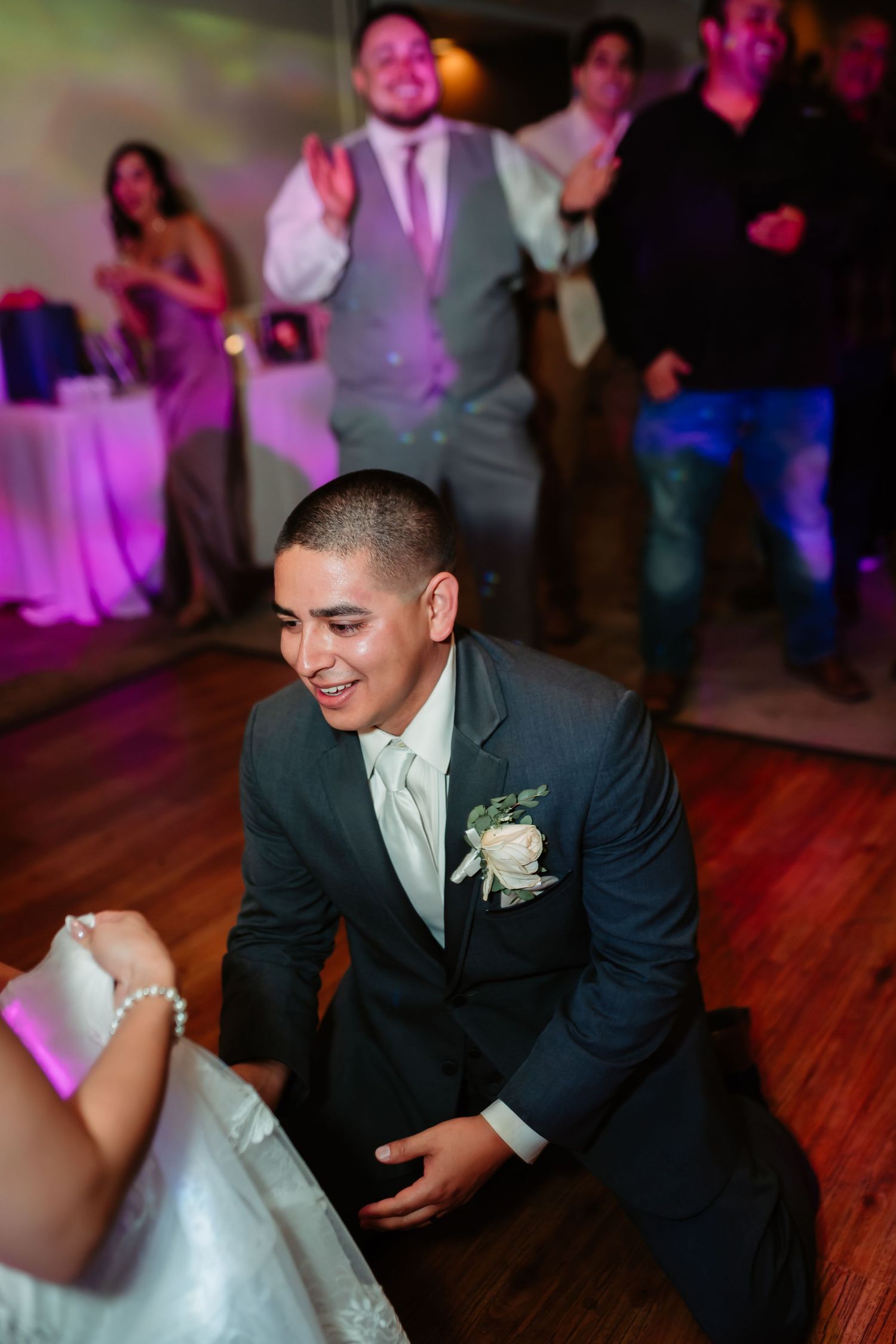 Wedding couple shares playful dance moves during their reception celebration.