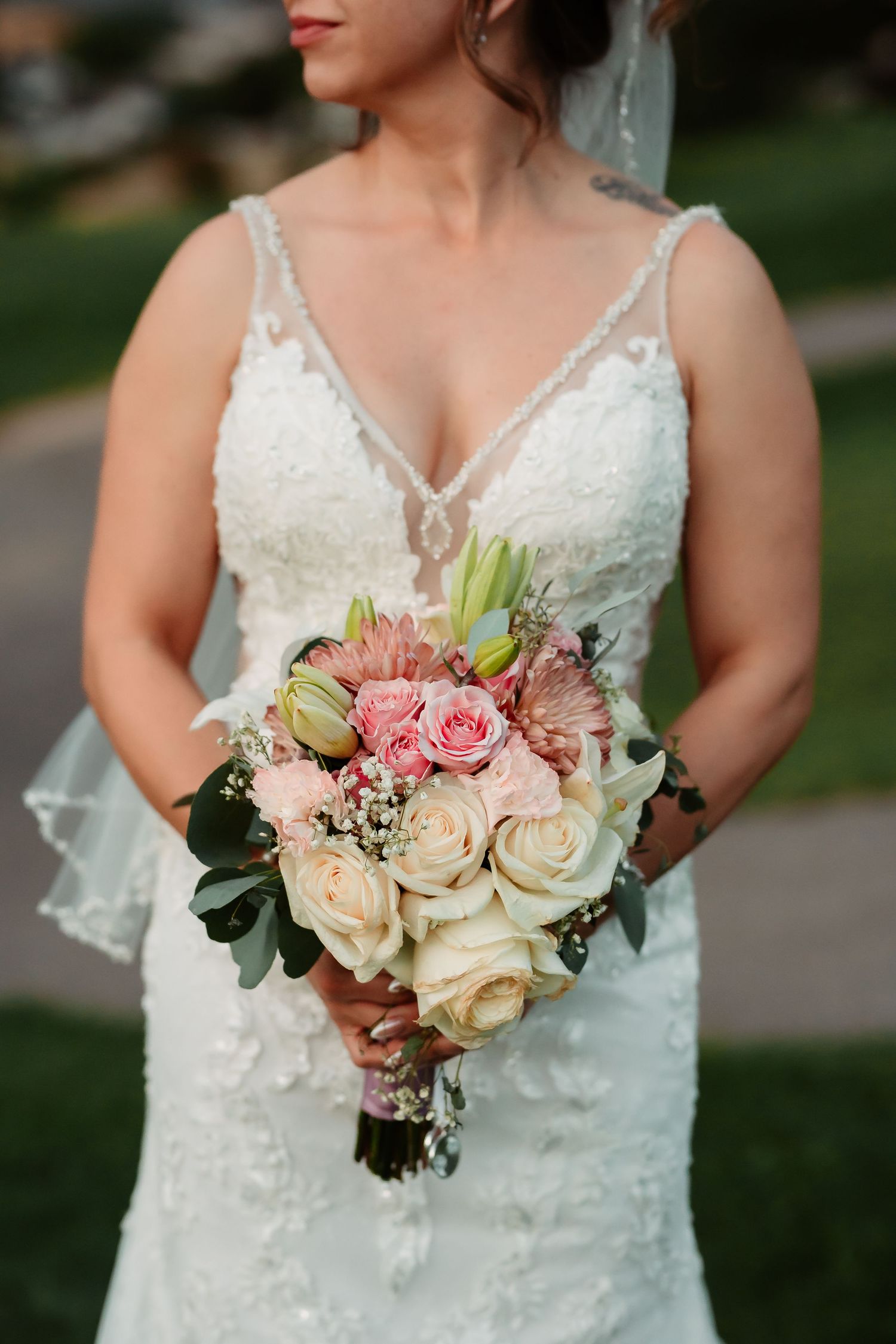 Beautiful bridal bouquet featuring pink and cream roses with eucalyptus leaves.