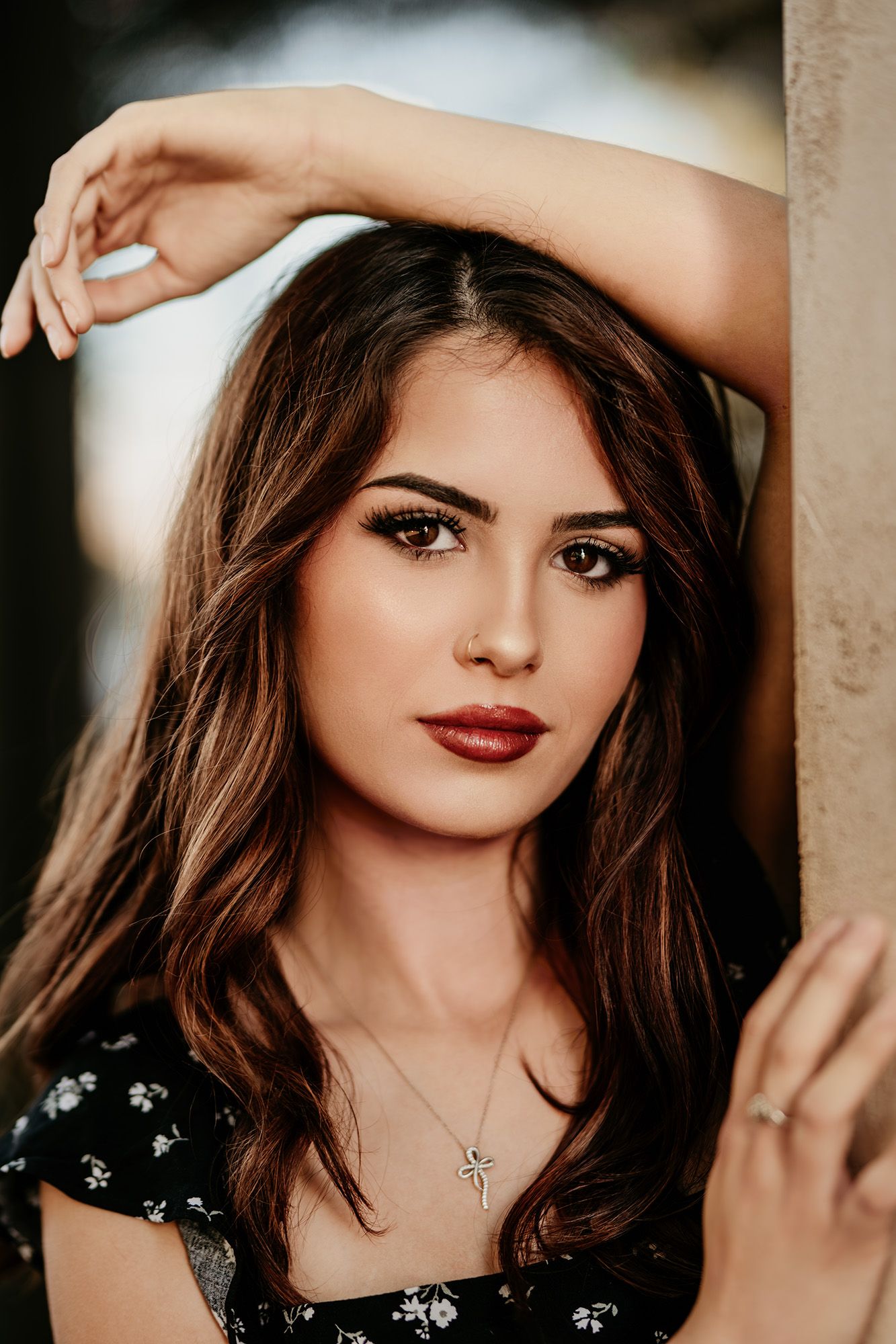 Portrait series showing close-up shots of a woman with brown hair wearing dark lipstick and a black floral top.