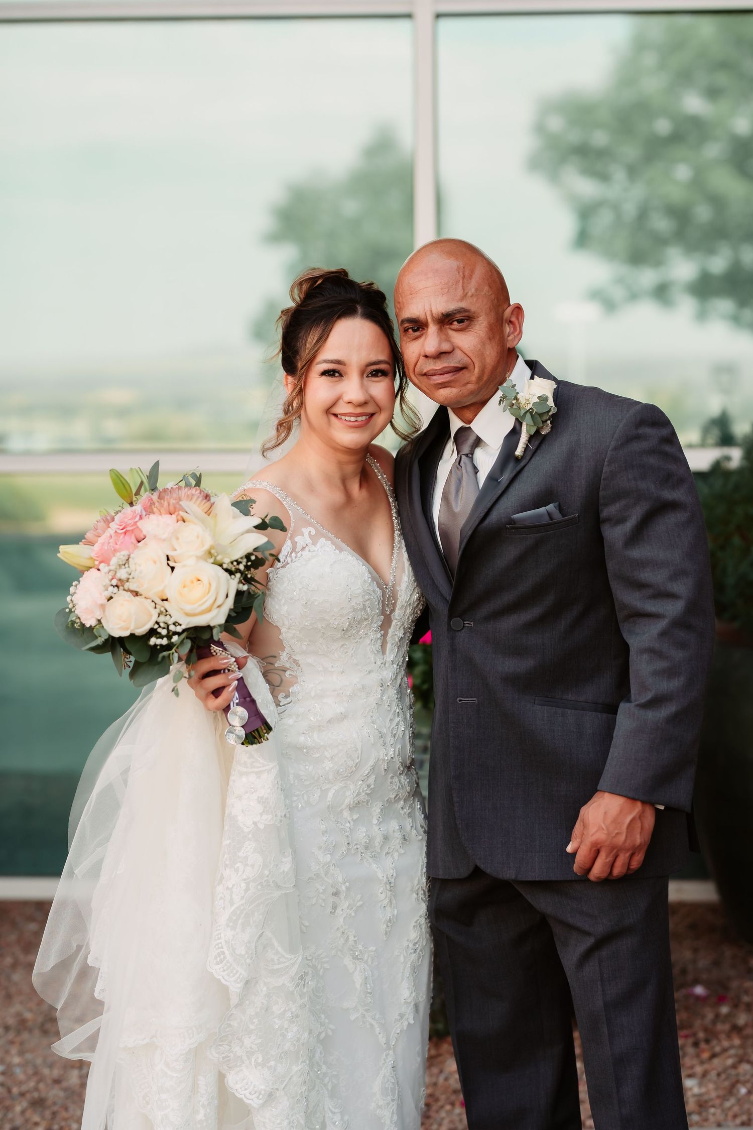 A romantic wedding photo series showing tender moments with the couple outdoors with soft pink and white floral bouquets.
