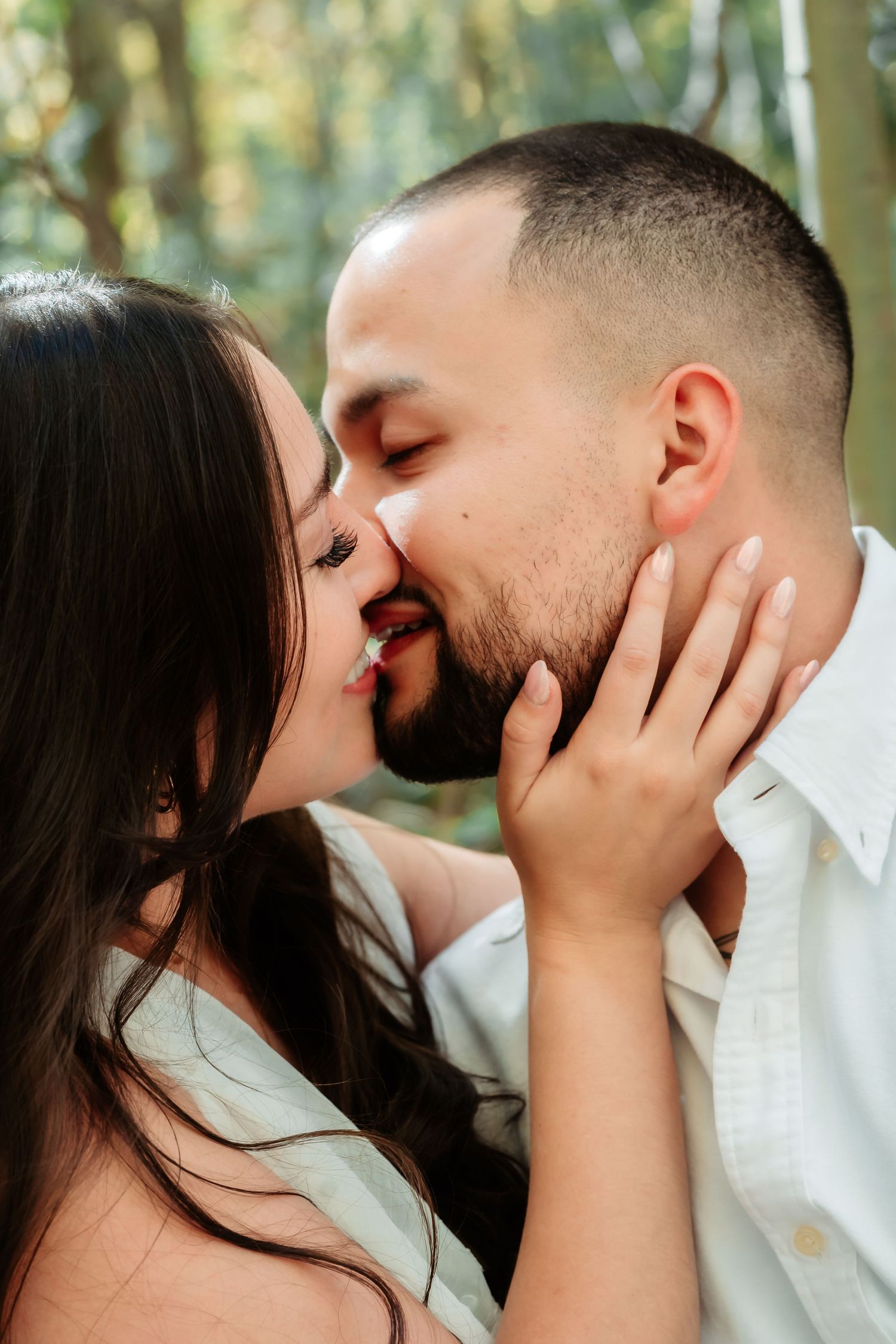Intimate close-up sequence of a couple sharing tender kisses against a bright natural background.