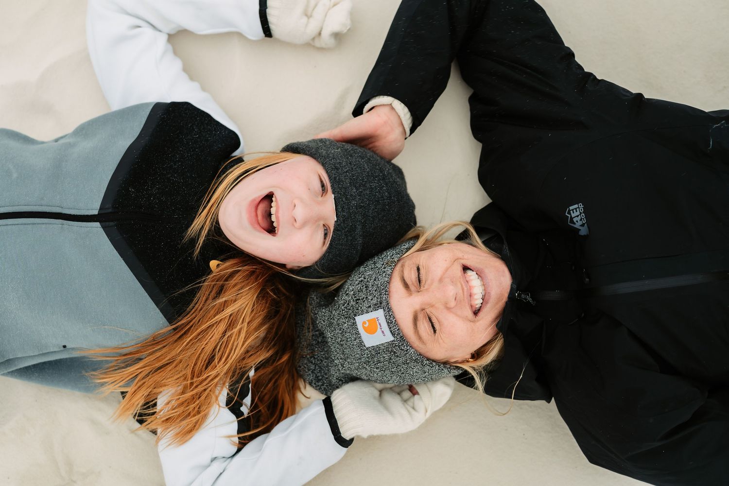 Candid black and white photos showing joyful laughter while lying down.