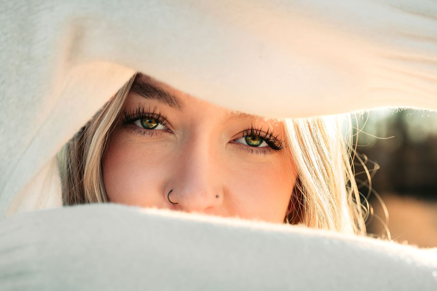 Close up portrait of a person with blonde hair and golden lighting in a soft, dreamy style.