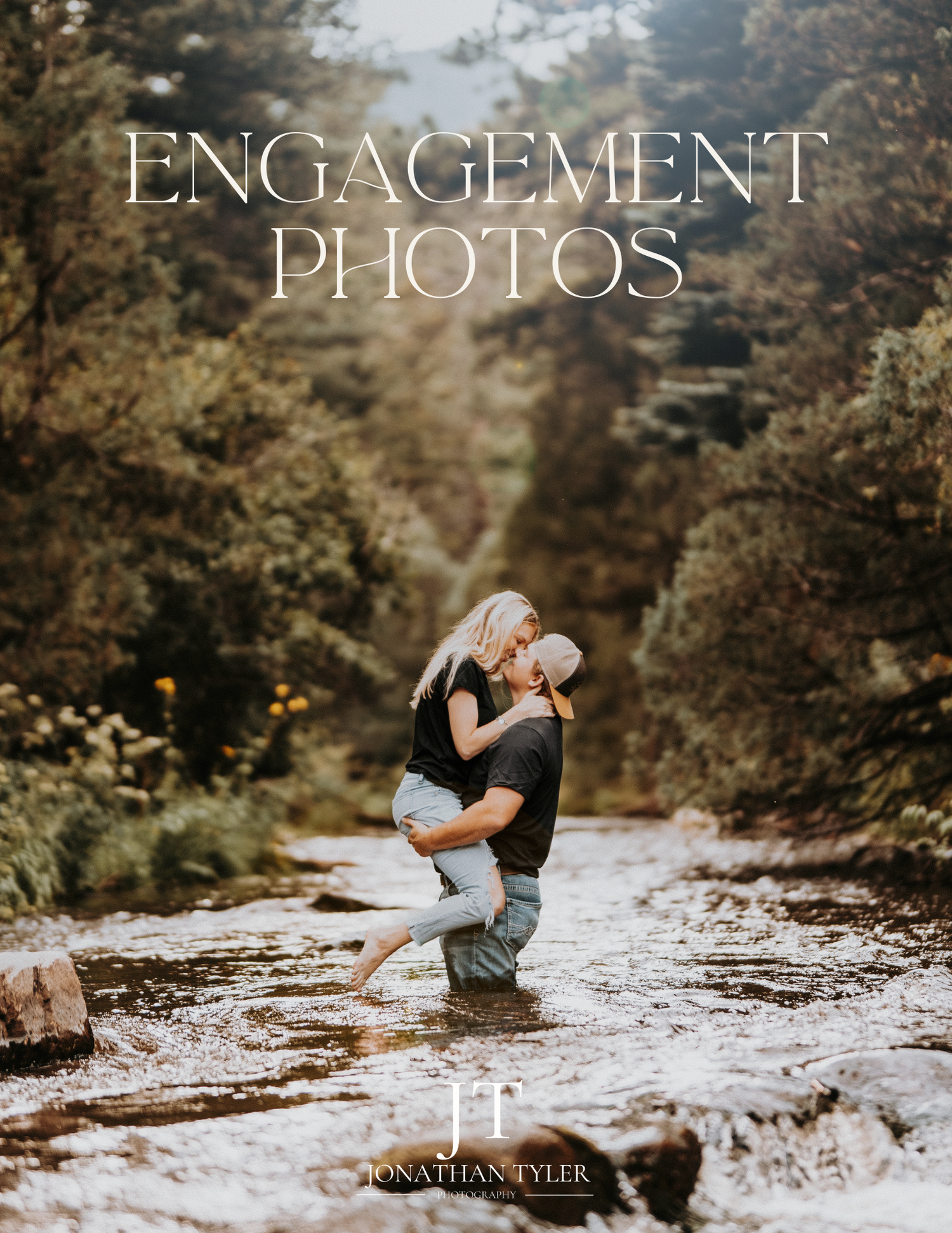A romantic couple embraces while standing in a scenic stream surrounded by autumn foliage and forest scenery.