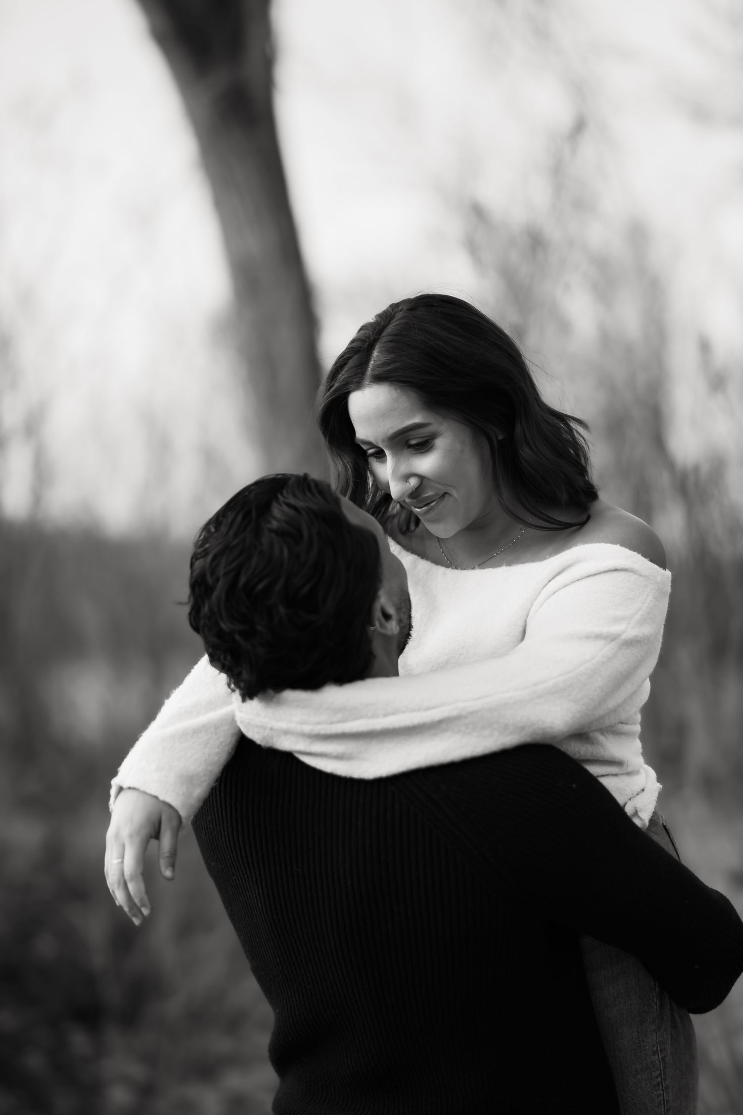 A romantic black and white photo sequence shows a couple embracing and dancing in nature.