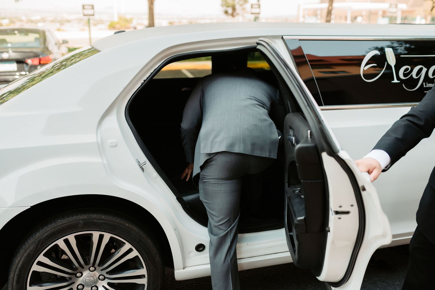 A close-up view of a car door opening, showing the sleek silver finish and luxurious interior details.