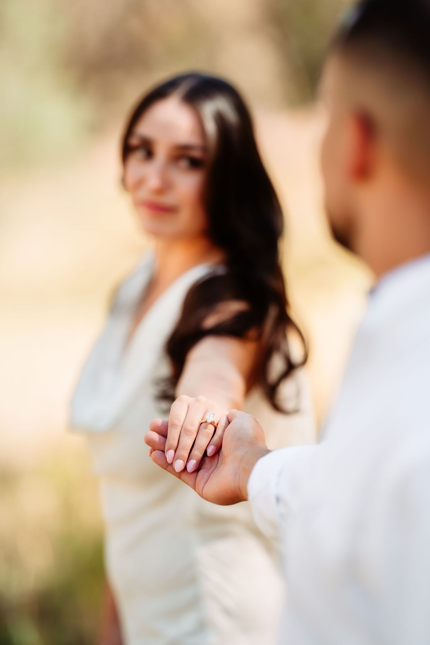 Close-up photo series showing engagement ring on hand with blurred romantic background.