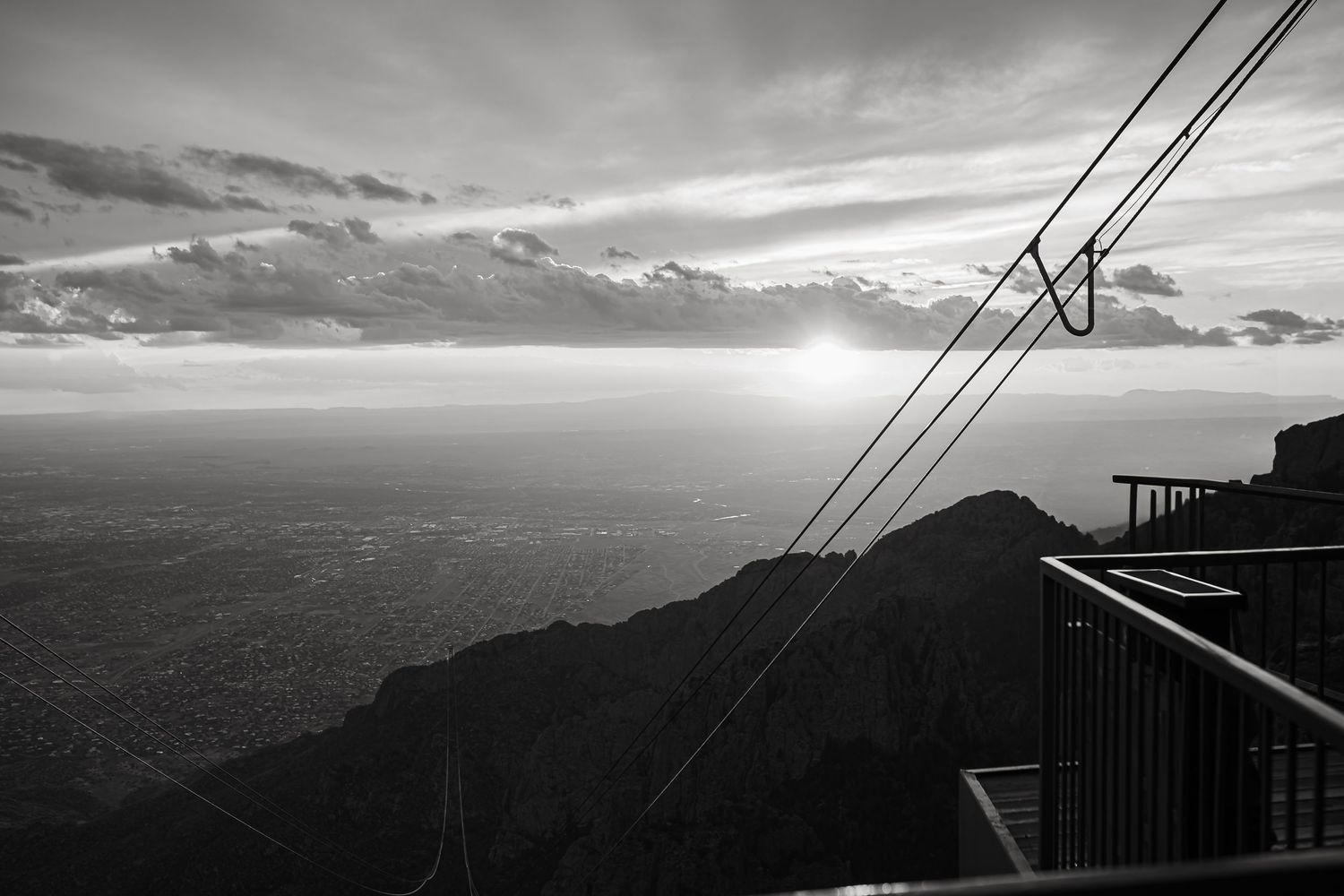Dramatic mountain ridgeline silhouette with power lines at sunset.