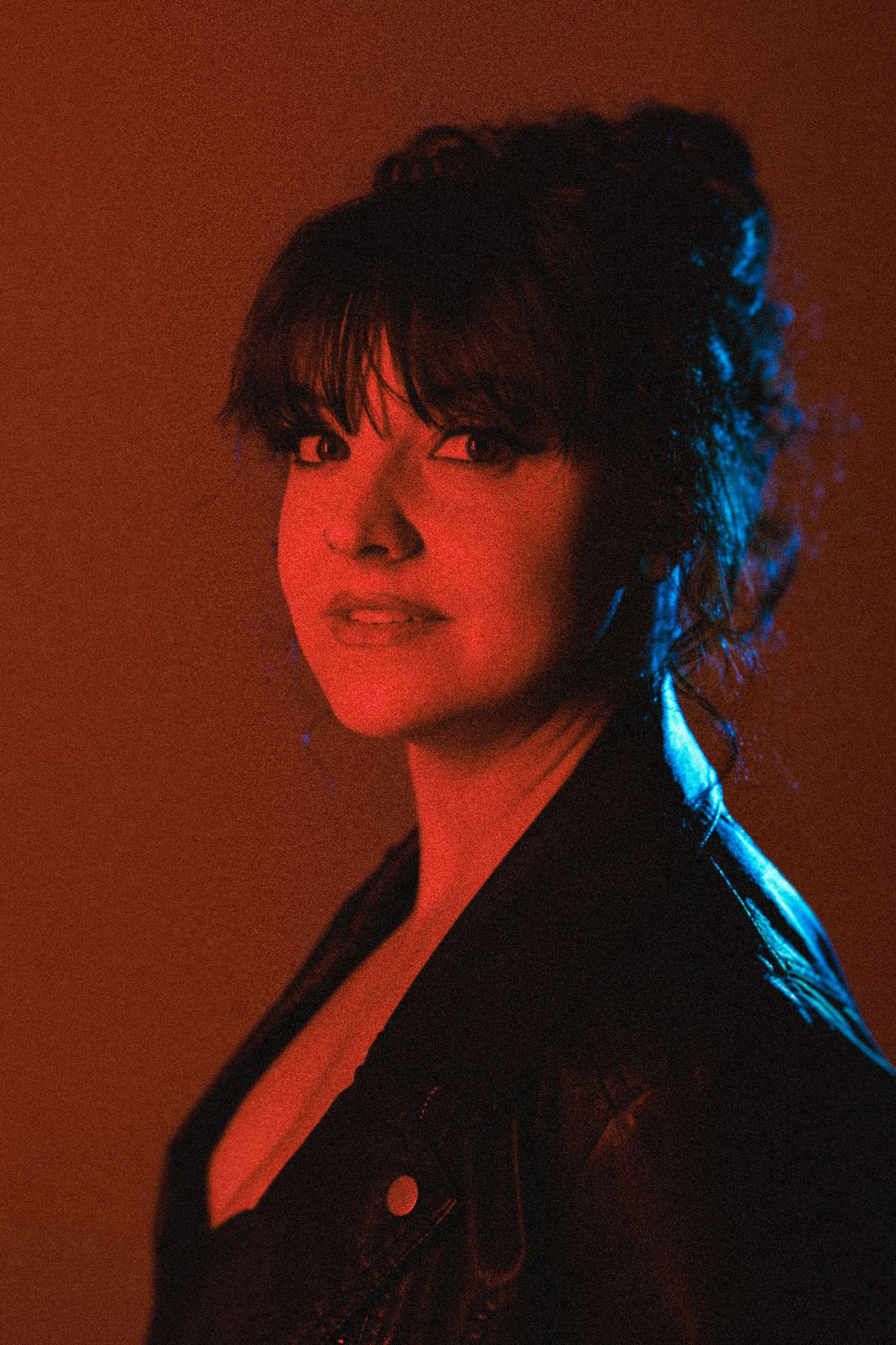 Dramatic portrait series with red lighting and dark background showing different poses and expressions.