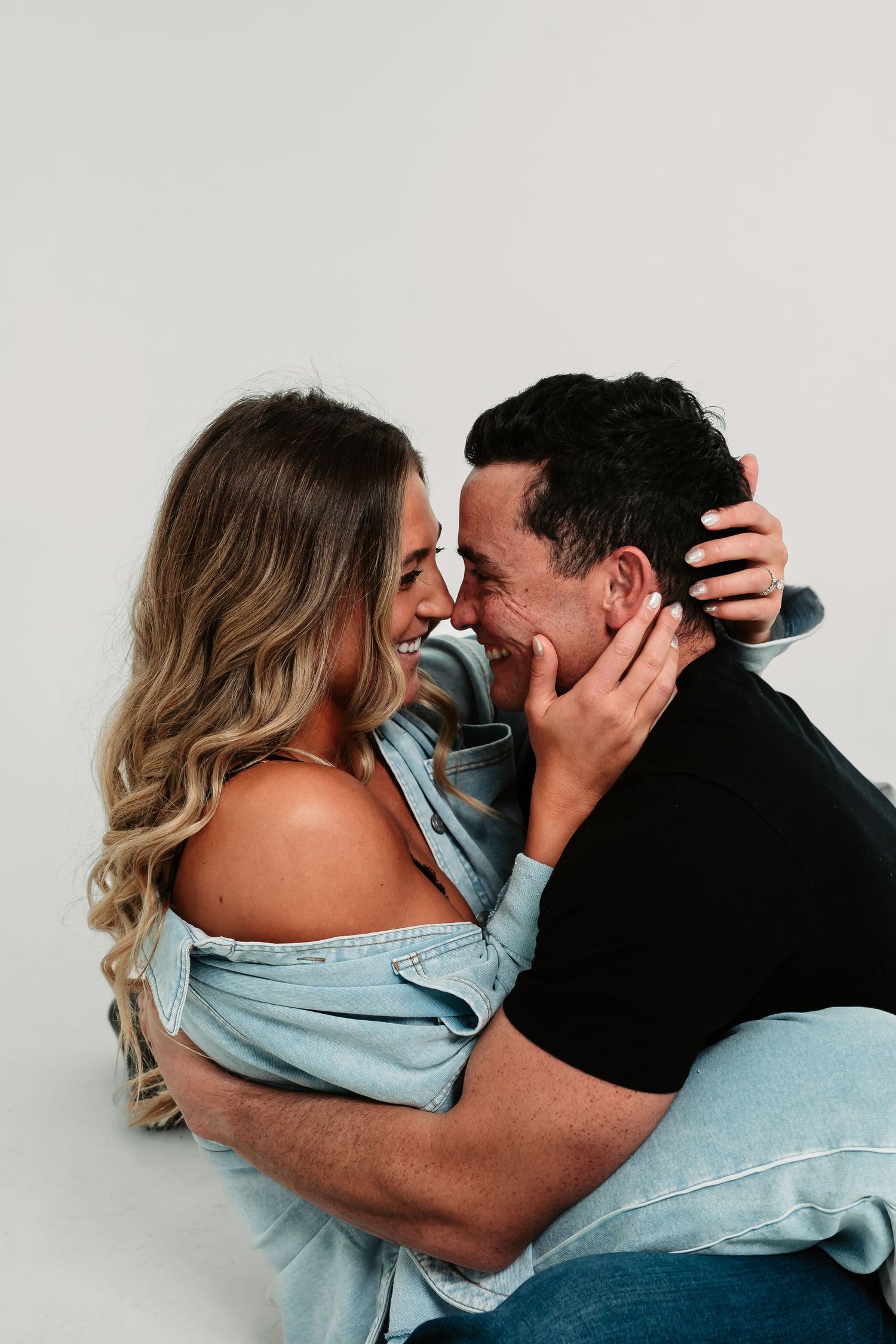 A romantic couple in denim embraces intimately in a series of candid black and white photographs.