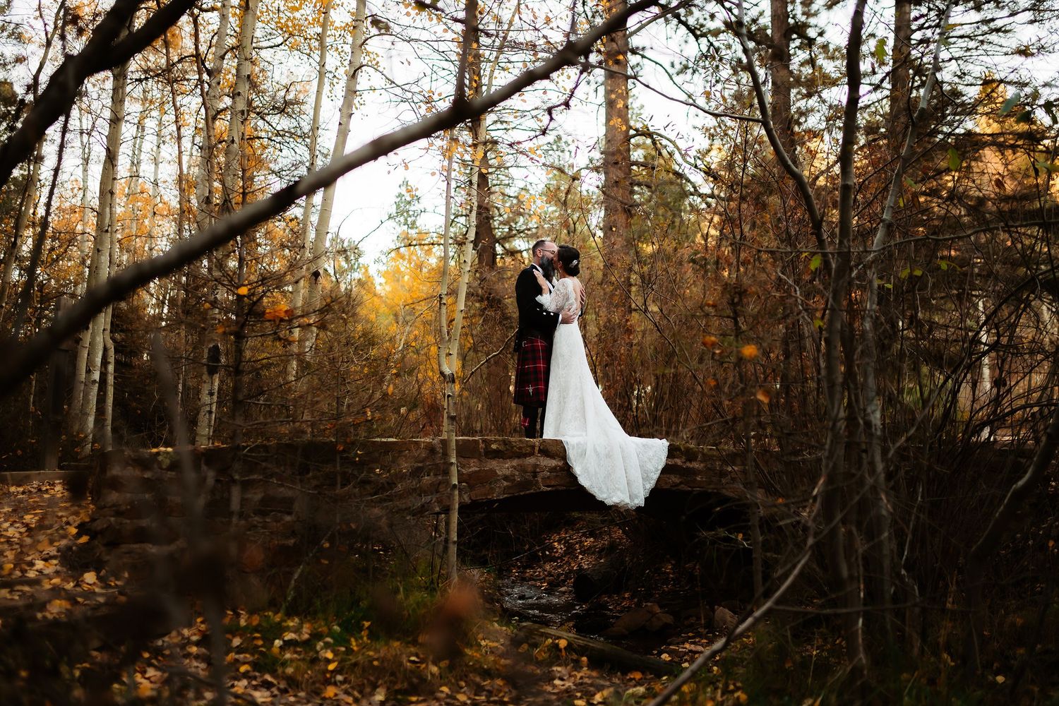 A person in a flowing white dress runs through an autumn forest with golden sunlight filtering through the trees.