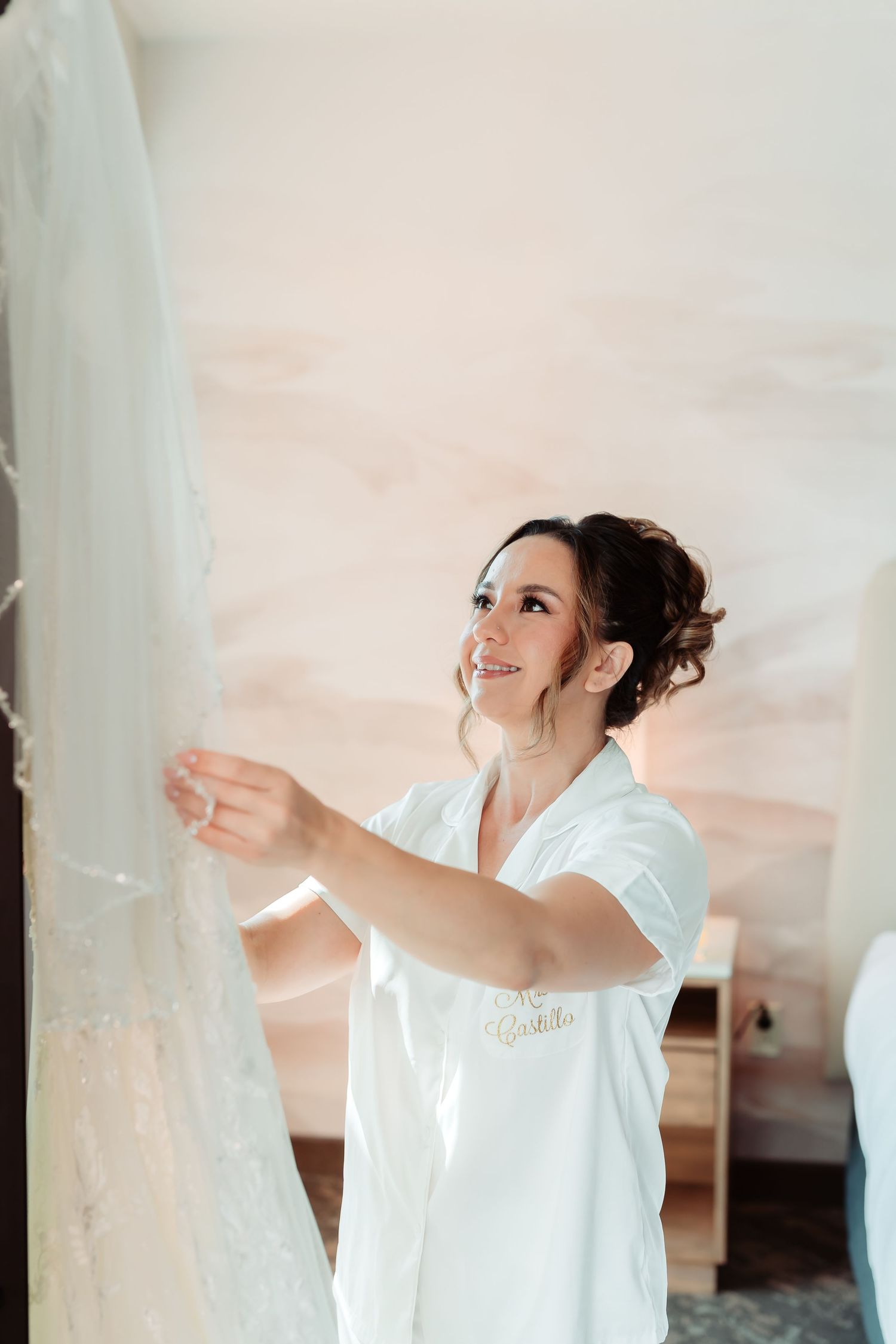 Close-up of someone in a white robe dancing joyfully against a light background.