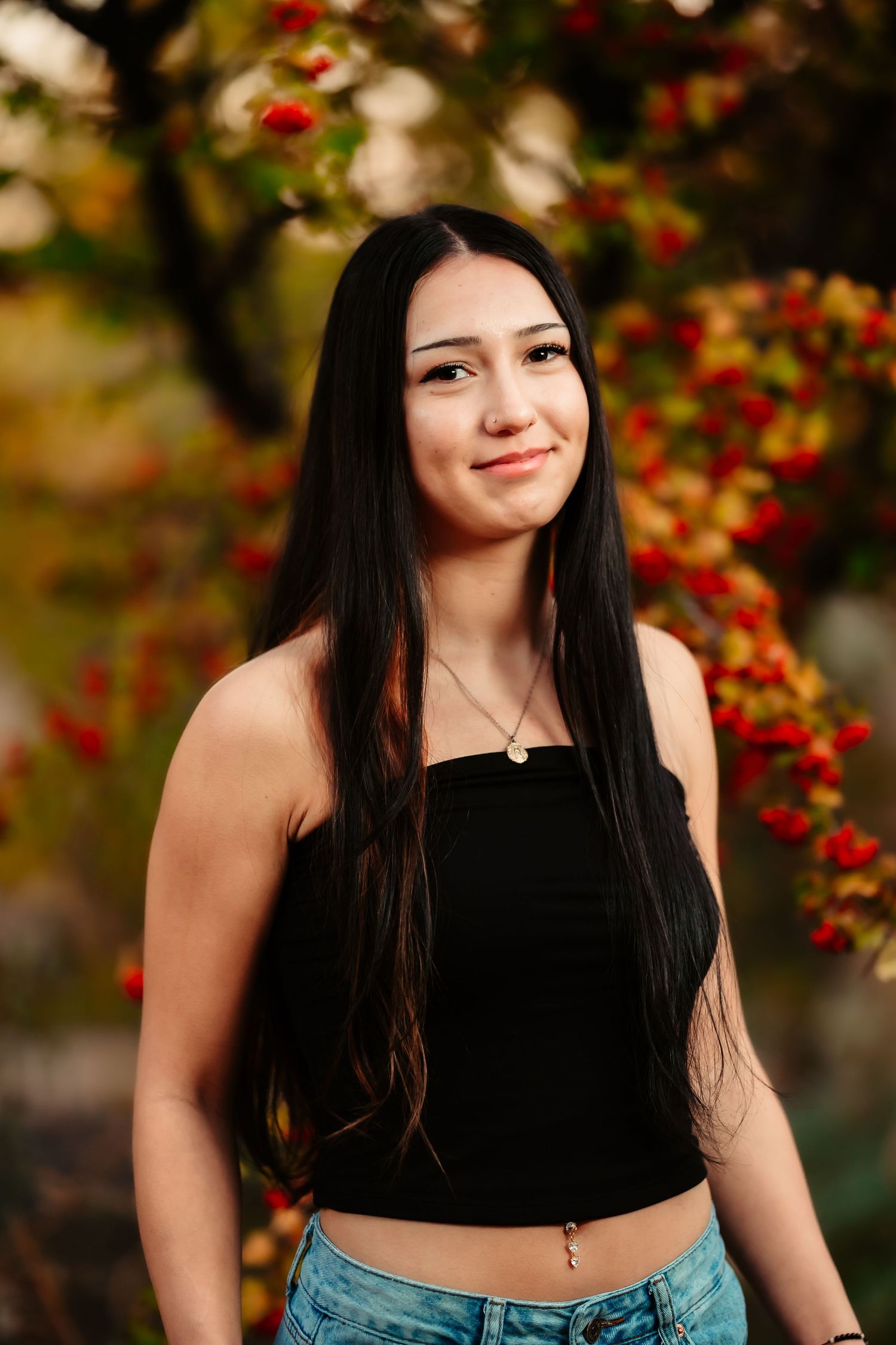 A series of outdoor portraits featuring long dark hair against a background of red berries and autumn foliage.