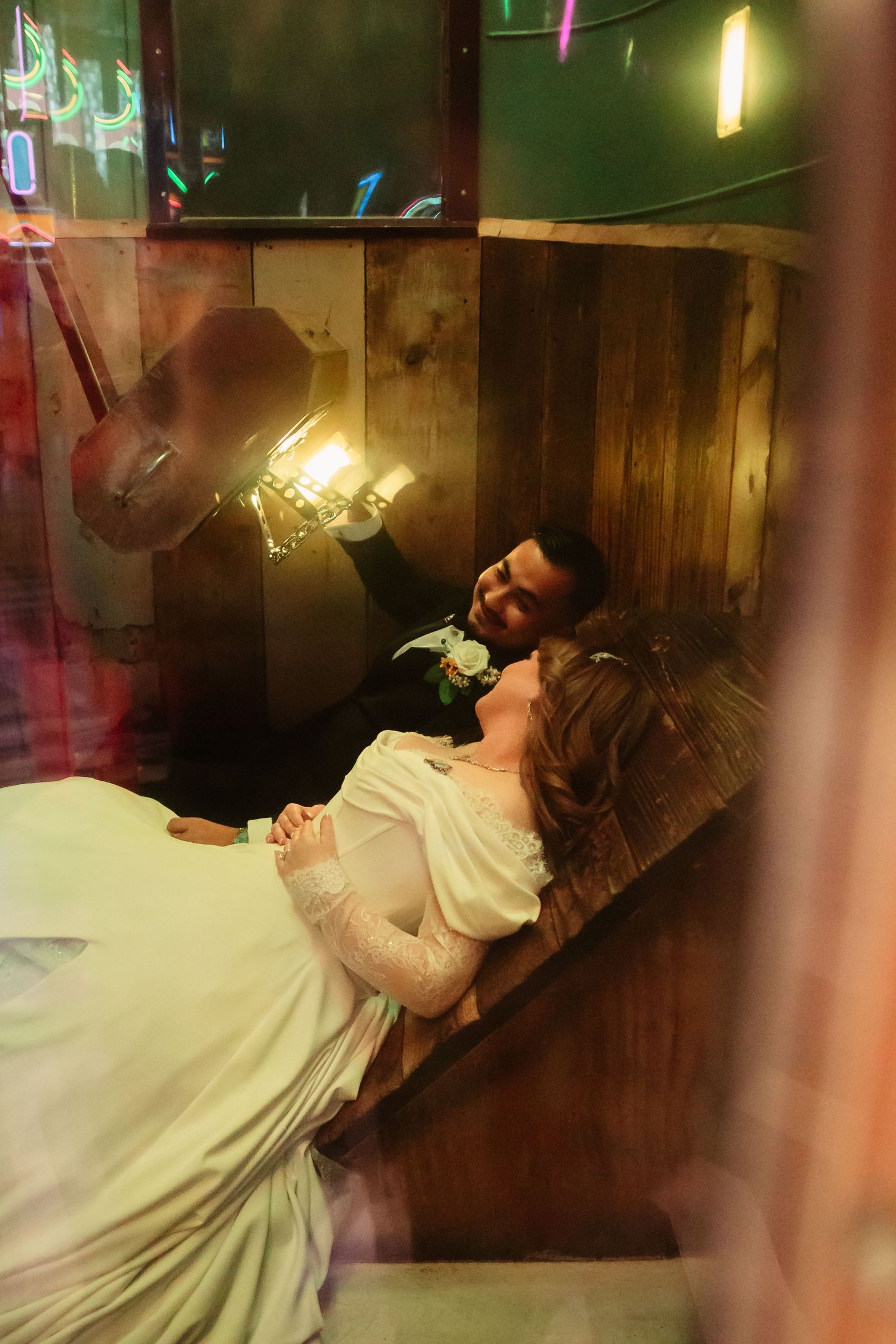 A sequence of images shows someone reclining on a wooden bench in a dimly lit room with colorful lights.
