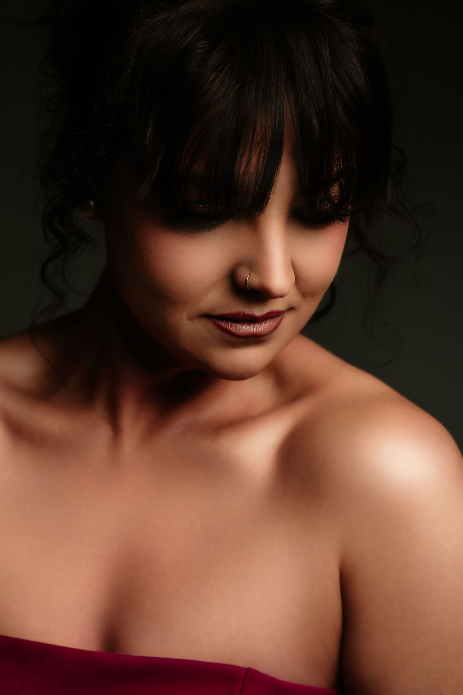 A series of artistic portrait photographs showing dark shadows and dramatic lighting against bare shoulders.
