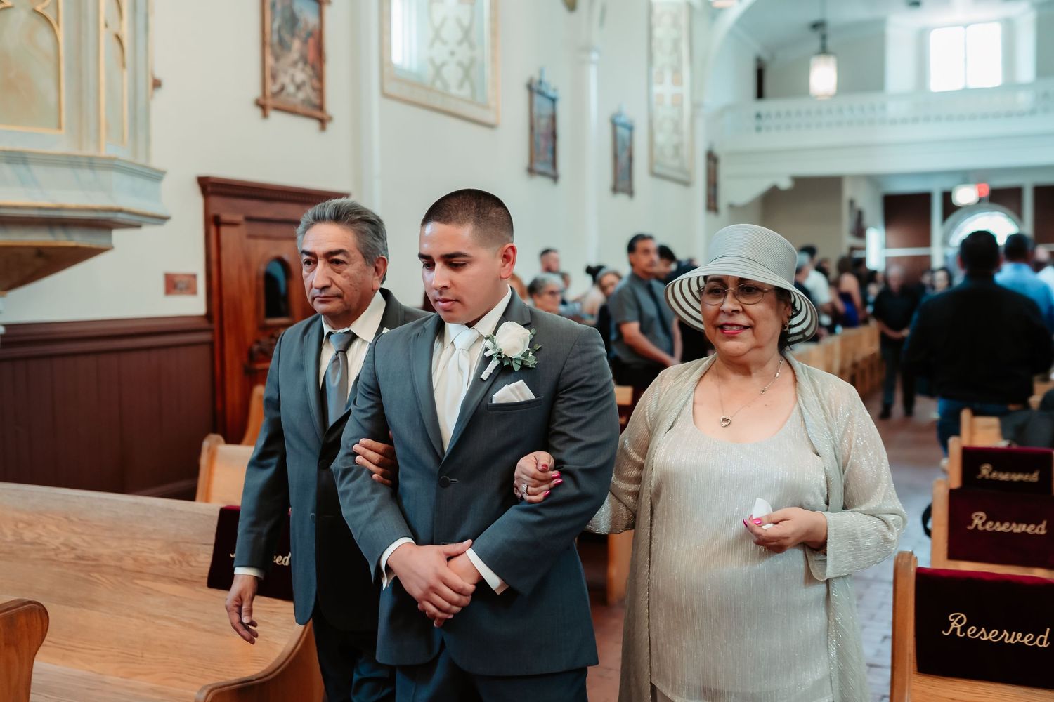 A romantic couple shares an intimate moment during a traditional indoor wedding ceremony.