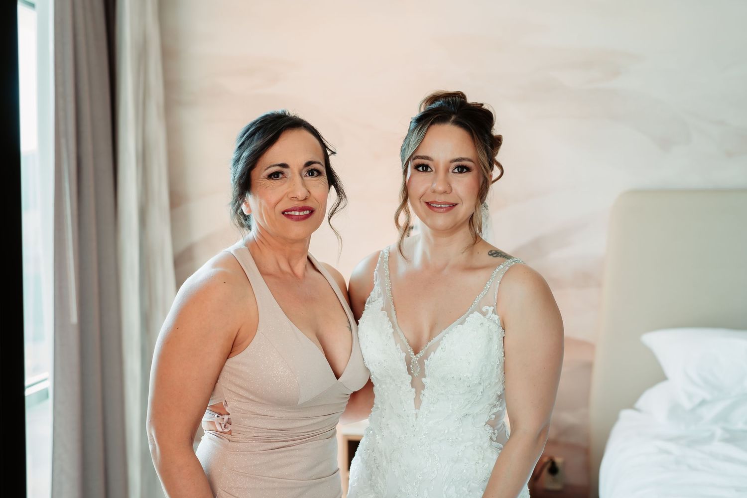Behind-the-scenes wedding preparation moment in a hotel room with soft lighting.
