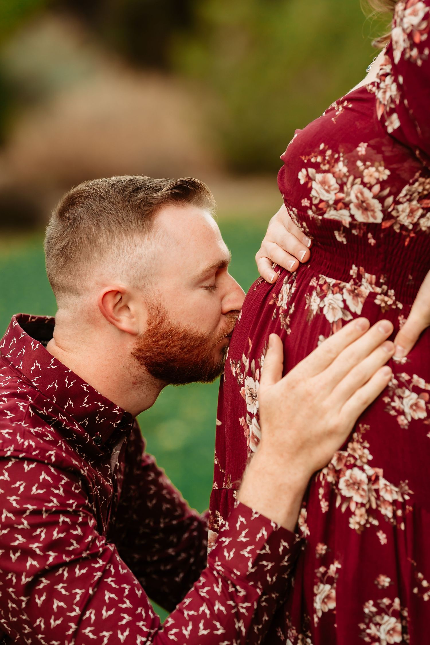 A series of side profile photos showing someone kissing a burgundy floral dress against a blurred outdoor background.
