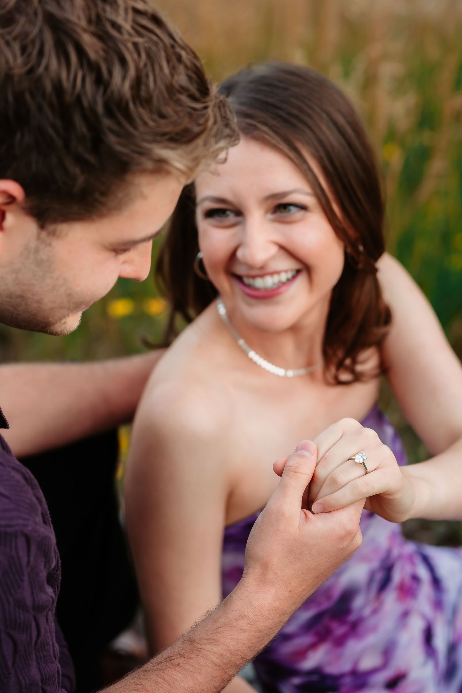 Close-up sequence of couple laughing and embracing during romantic outdoor photoshoot.