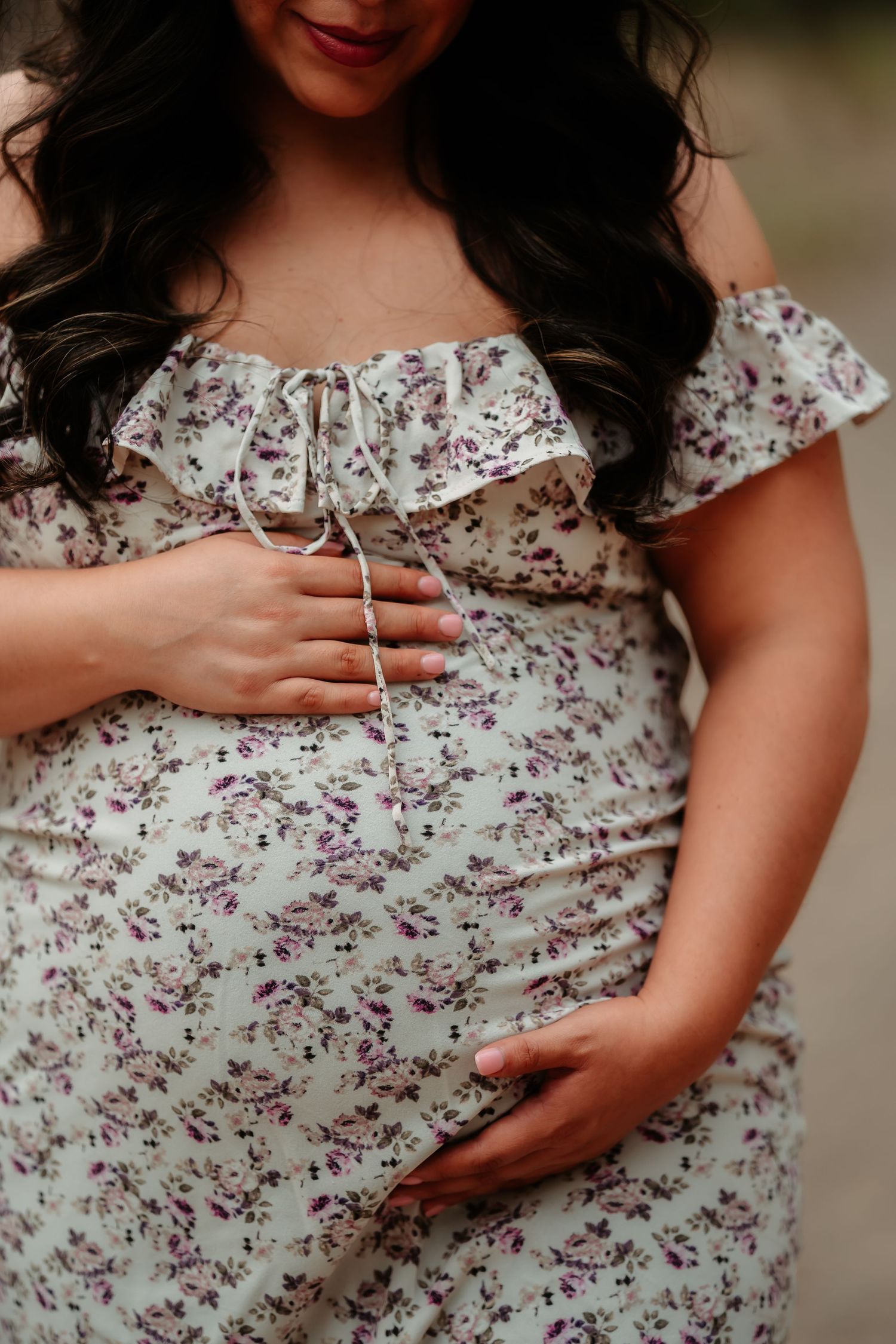 Close-up shots of a pregnant belly in a floral dress showing the progression of pregnancy.