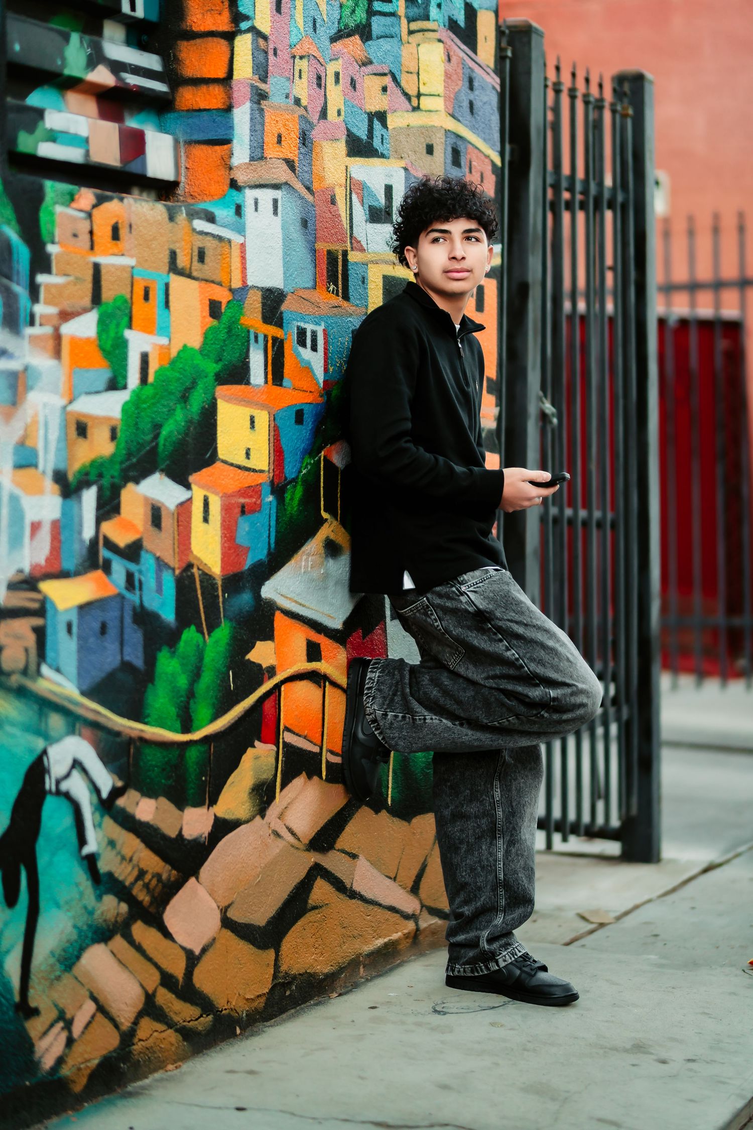 Urban street art photography sequence showing dynamic poses against a colorful geometric mural on a city wall.