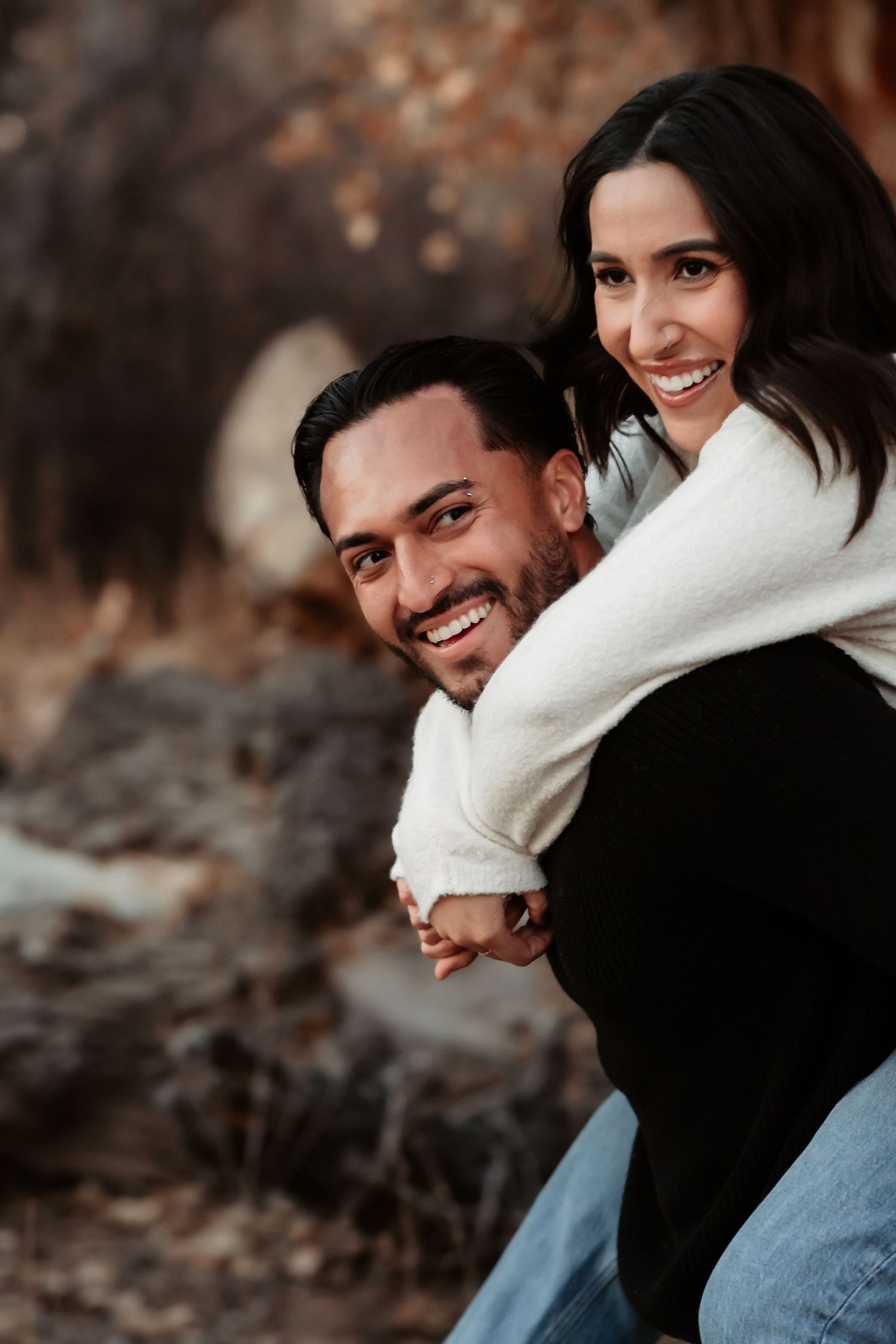 Couple sharing tender romantic moments in a series of candid outdoor photos with autumn colors in background.