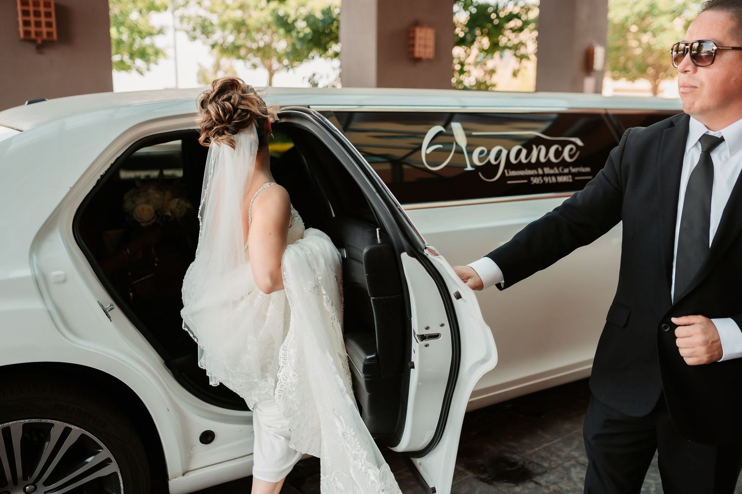Elegant bride and groom share an intimate first look moment outside with car waiting at their formal wedding.