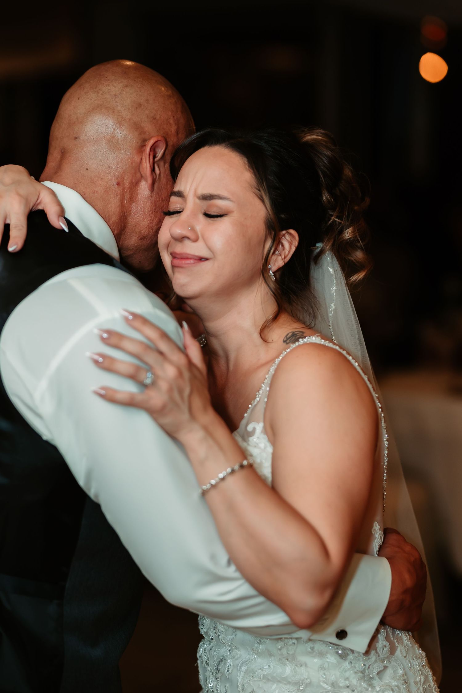 Emotional dance moments captured between the bride and her dance partner at the wedding reception.