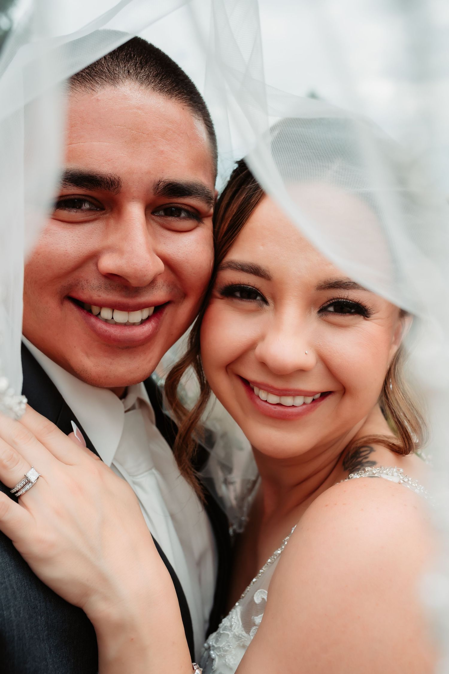 Close-up wedding photos showing intimate moments between a couple in formal attire with joyful expressions.