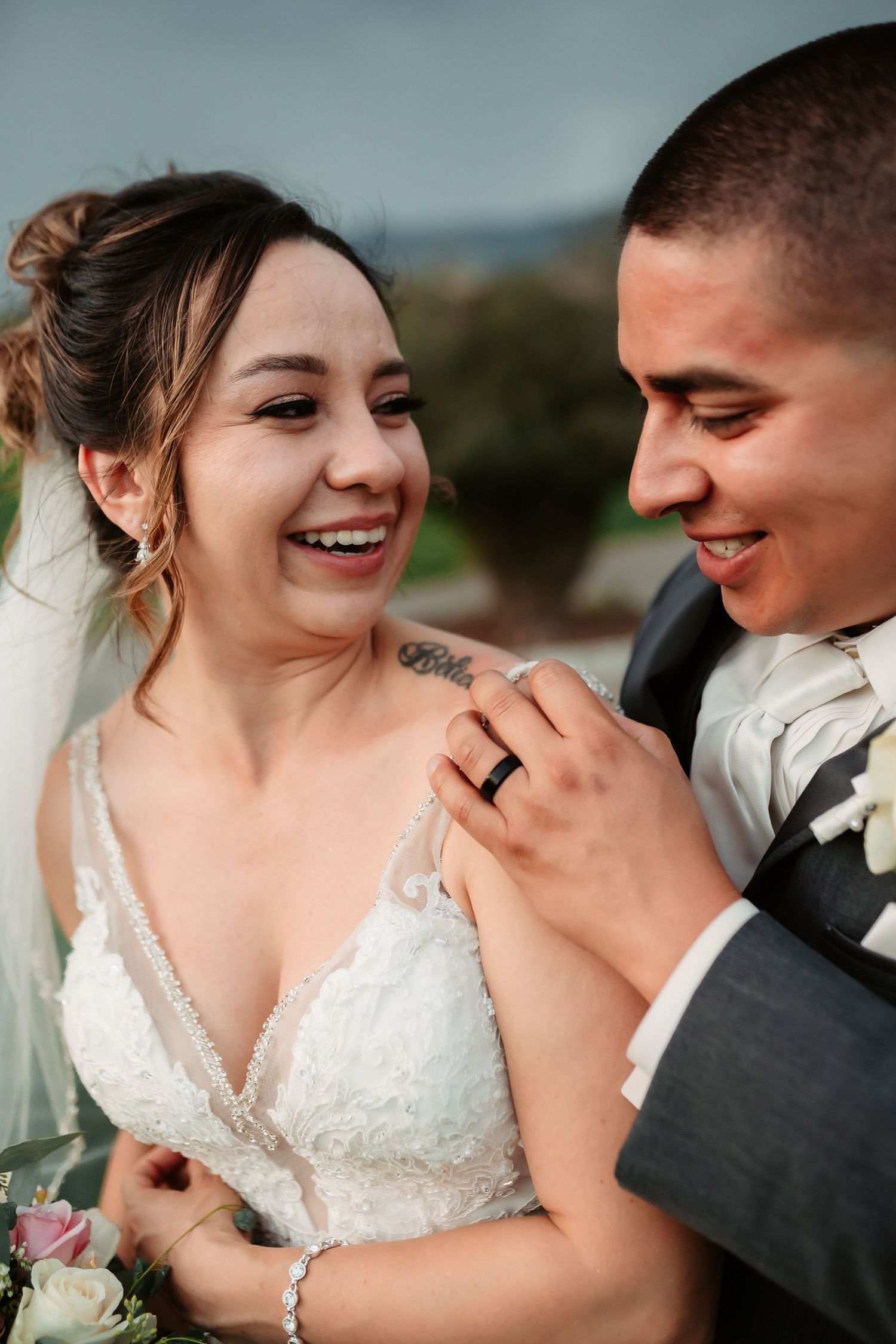 Candid close-up of joyful laughter during wedding photoshoot.