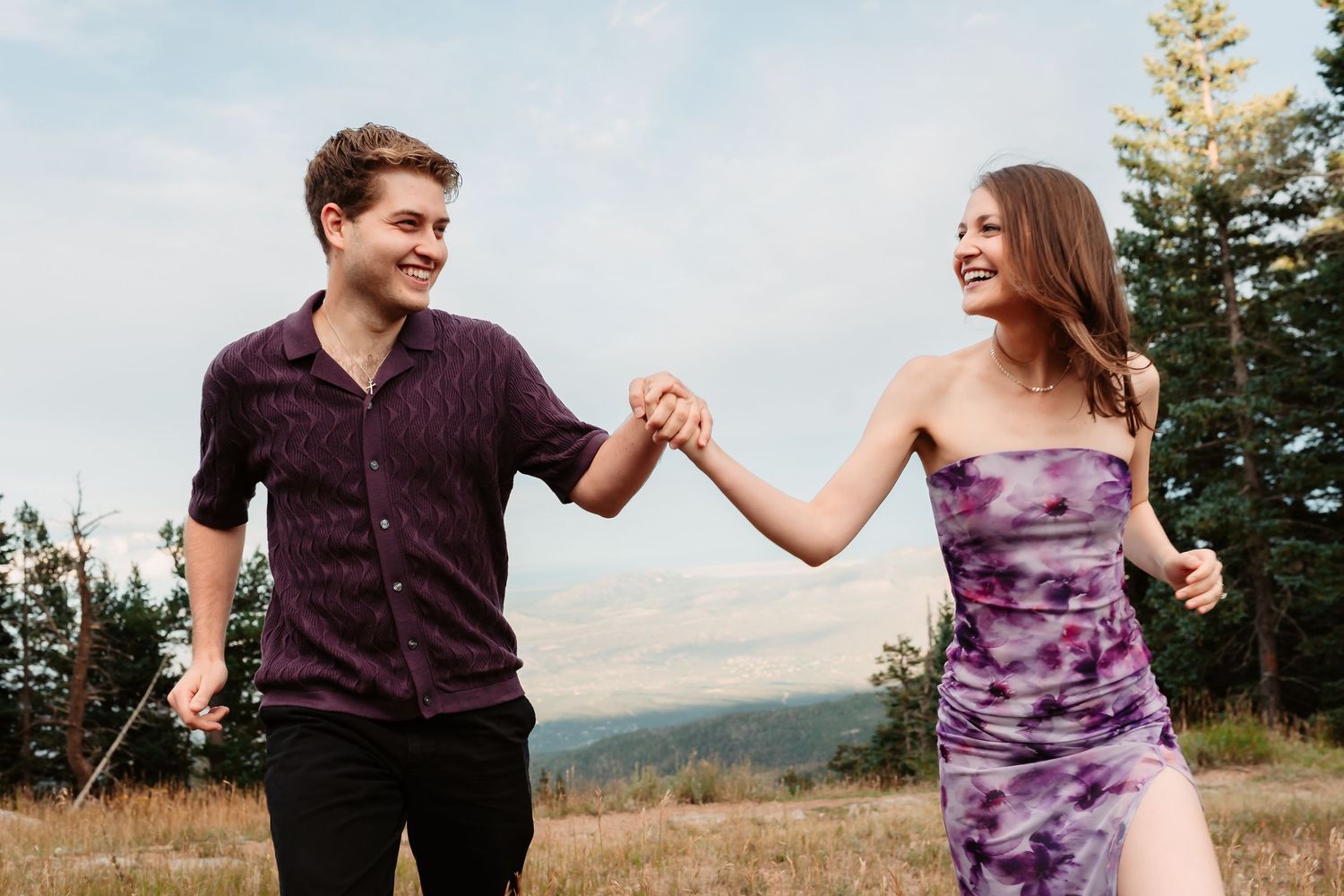 Joyful dance sequence of couple twirling in mountain meadow during sunset.