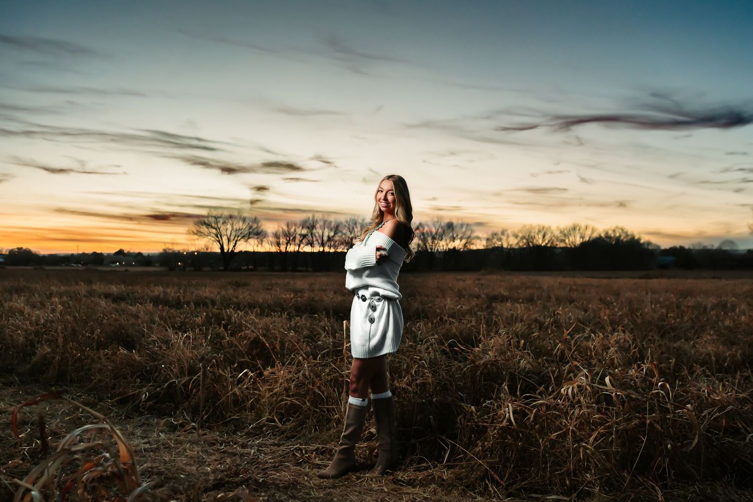 A series of romantic sunset engagement photos captured in a golden field with warm autumn lighting and dramatic skies.
