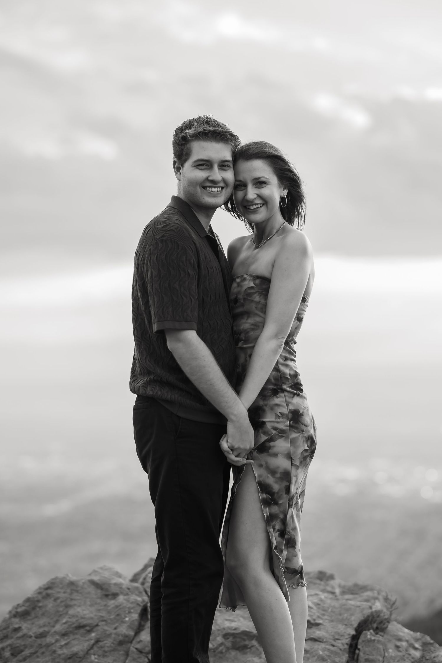 A black and white romantic photoshoot on a scenic mountain overlook.