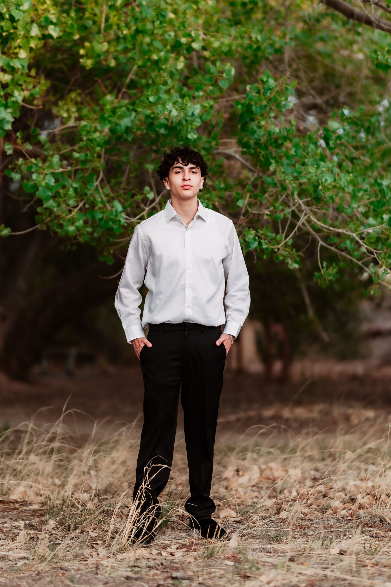 Classic white shirt and black pants ensemble photographed in outdoor woodland setting.