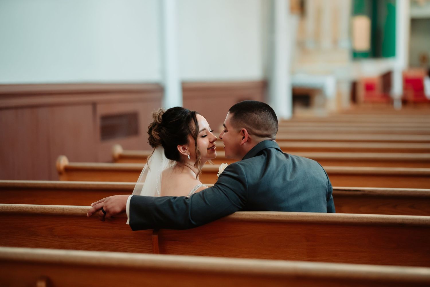 A series of romantic wedding photos showing couples embracing in church pews during their ceremonies.
