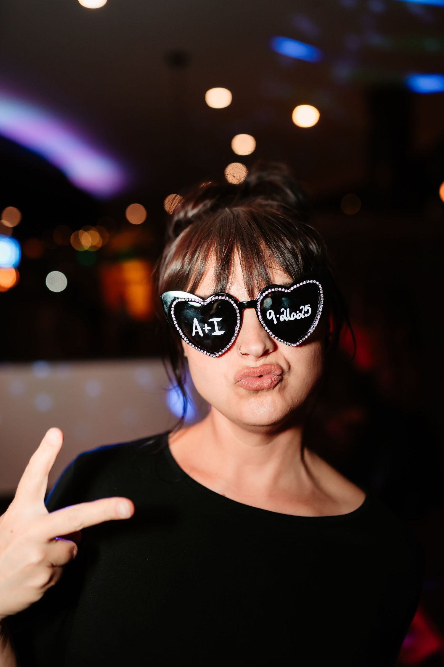 A series of photos showing someone in sunglasses making peace signs against a dark background with blurred lights.