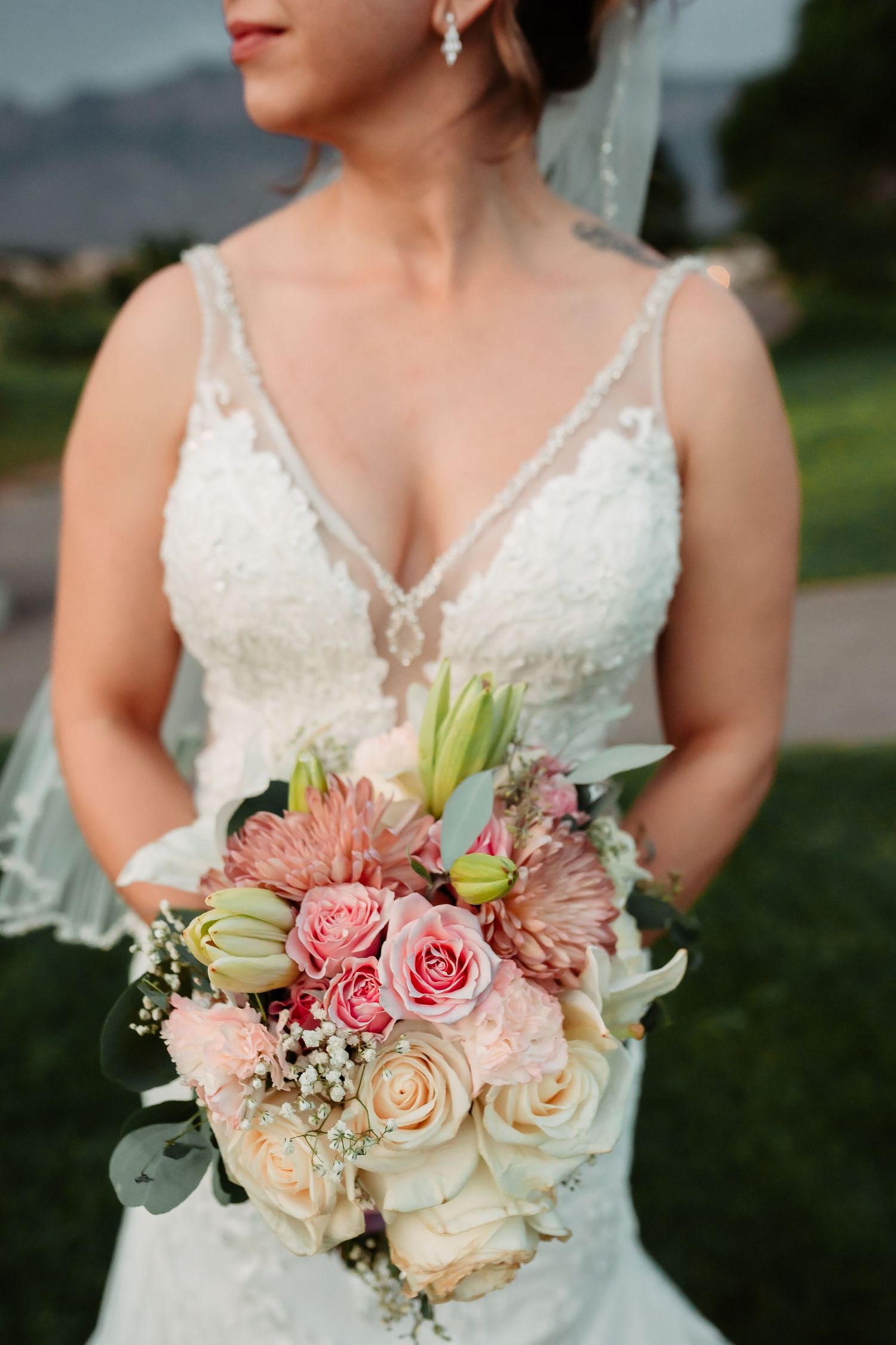 Delicate pink and ivory wedding bouquet with roses and mixed flowers.