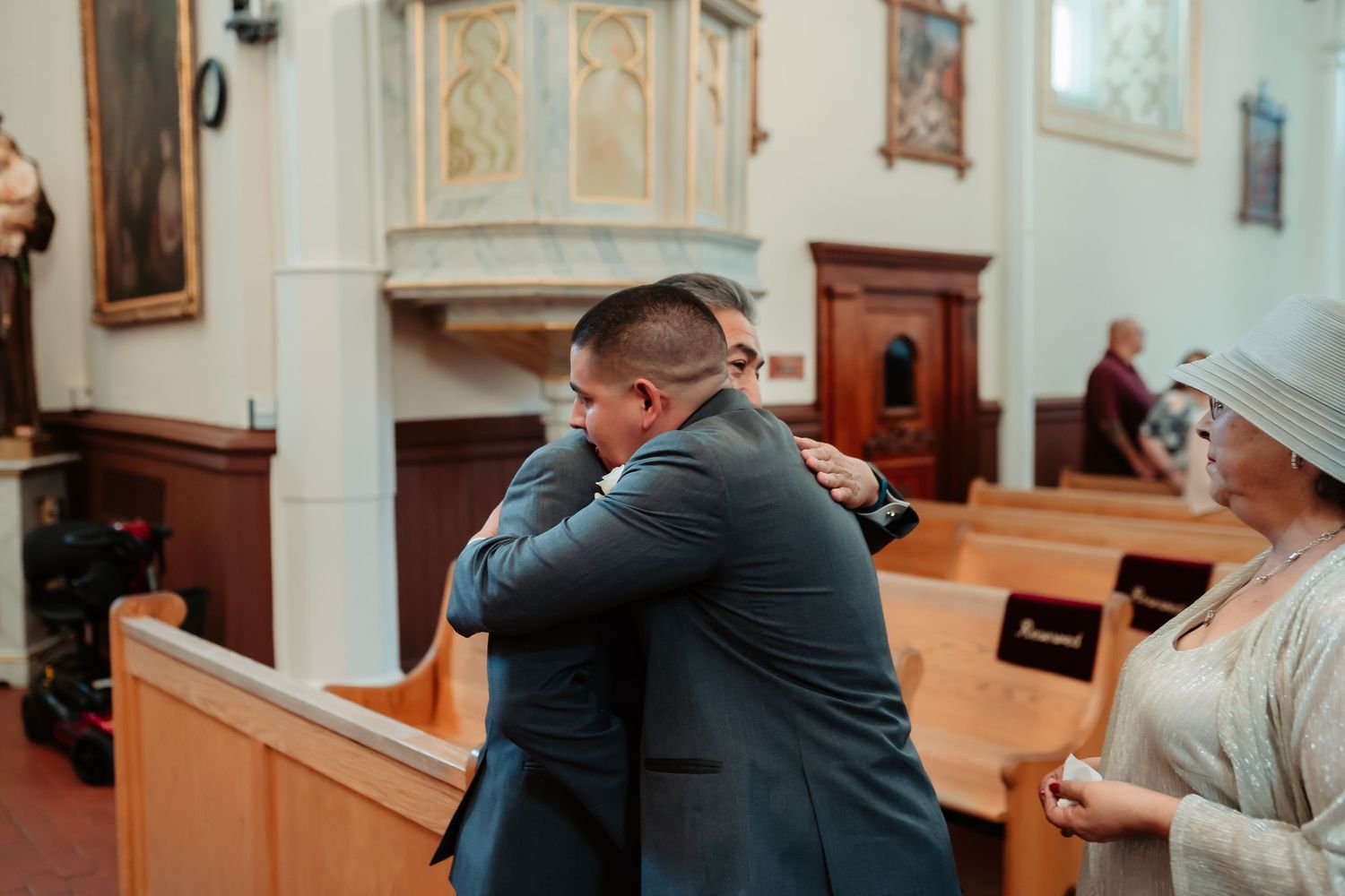 A couple exchanging vows during an intimate ceremony in an elegant church sanctuary.