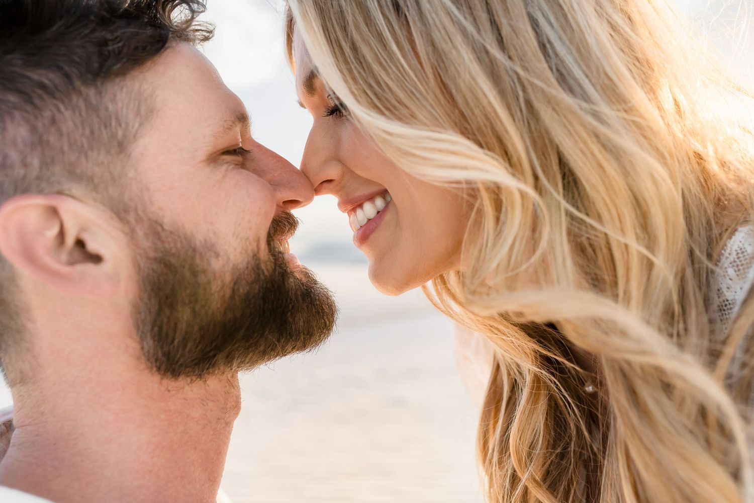 Close up shot of a romantic couple sharing an intimate moment with soft lighting.