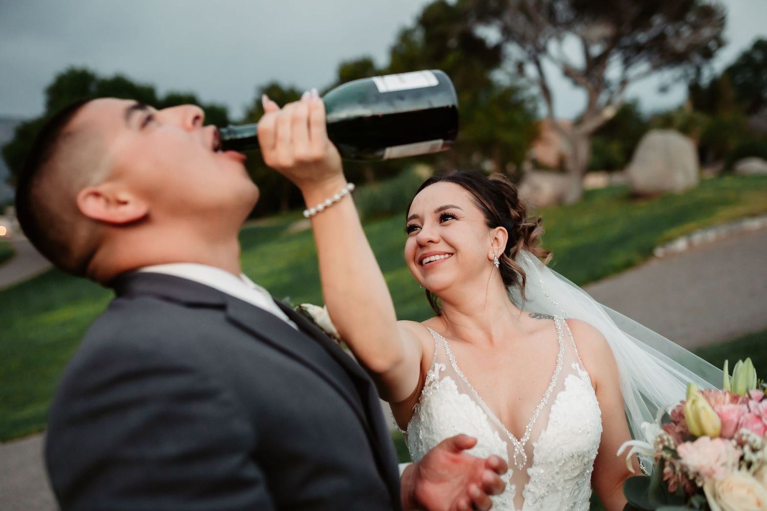 Candid wedding celebration moments captured on a scenic hilltop with champagne toast.