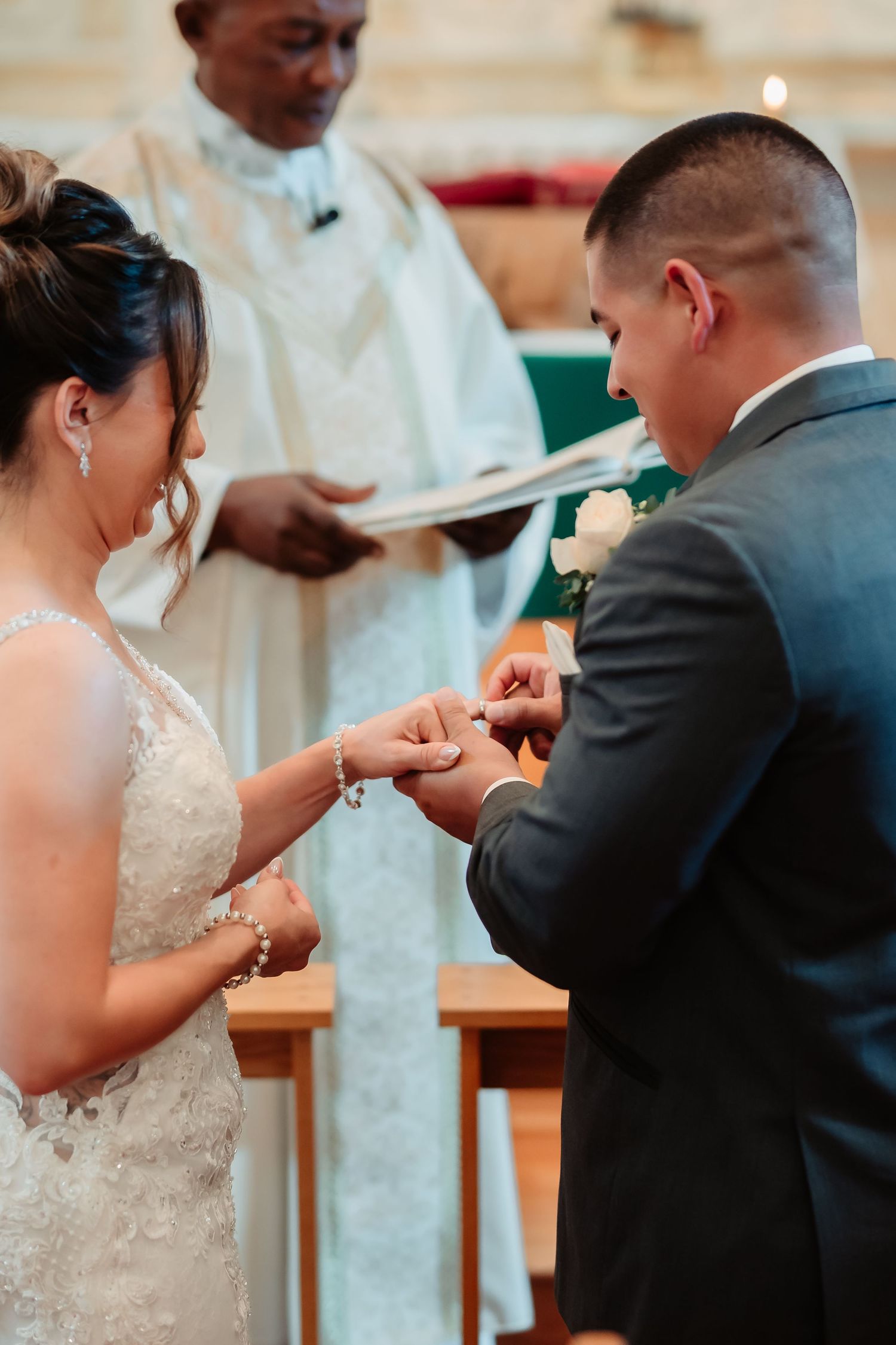 A traditional Catholic wedding ceremony showing exchange of rings at the altar.