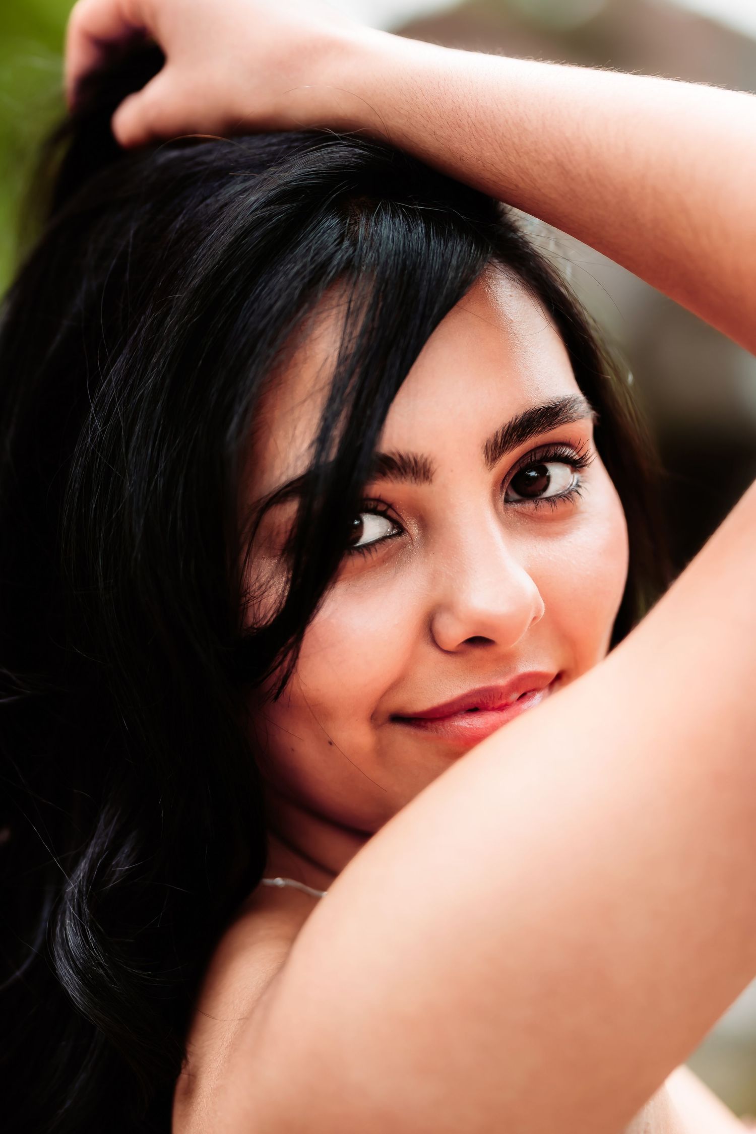 A series of artistic portrait shots showing dark hair and expressive eyes in varying poses.