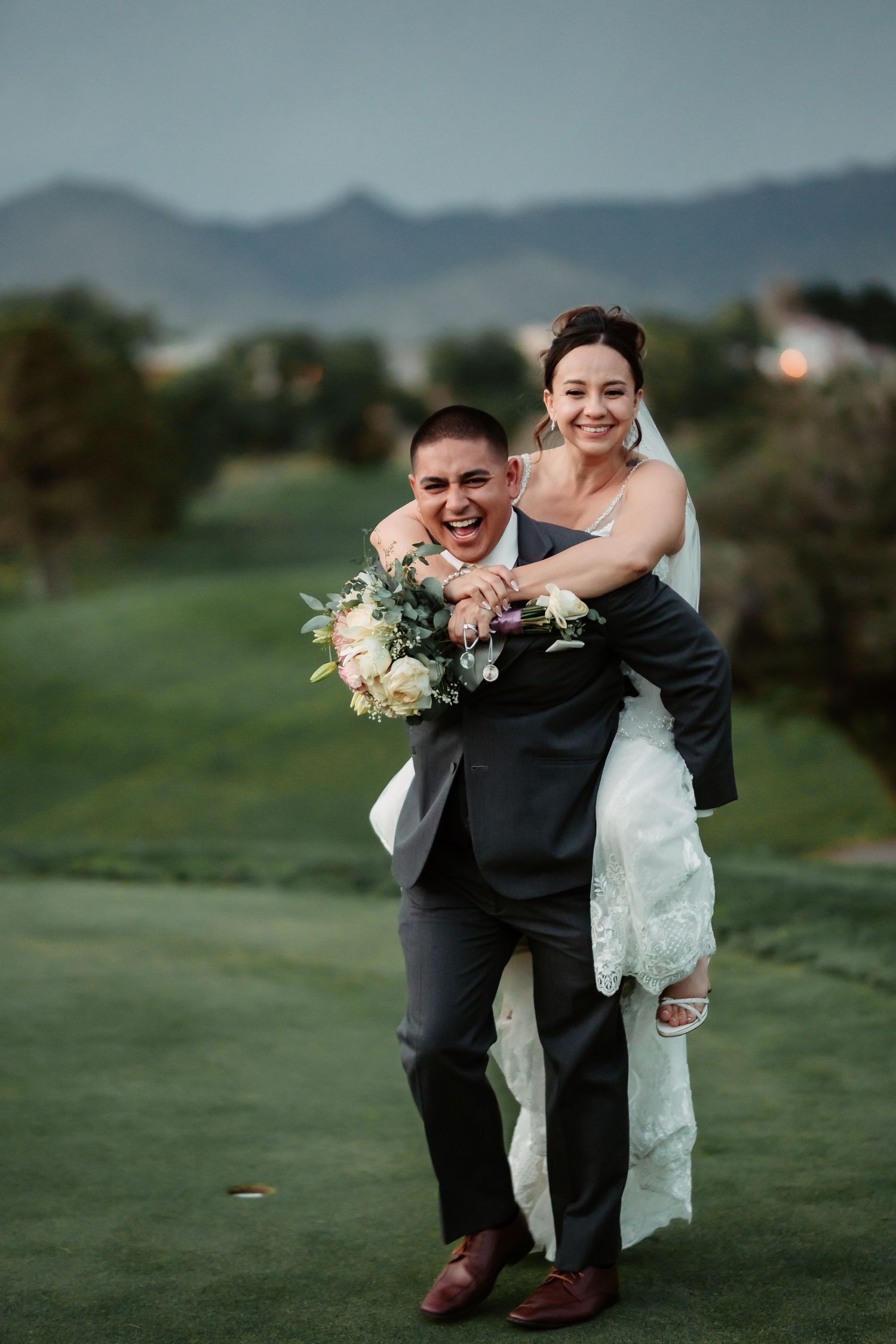 Playful wedding photography sequence showing couple in dynamic poses on grass.