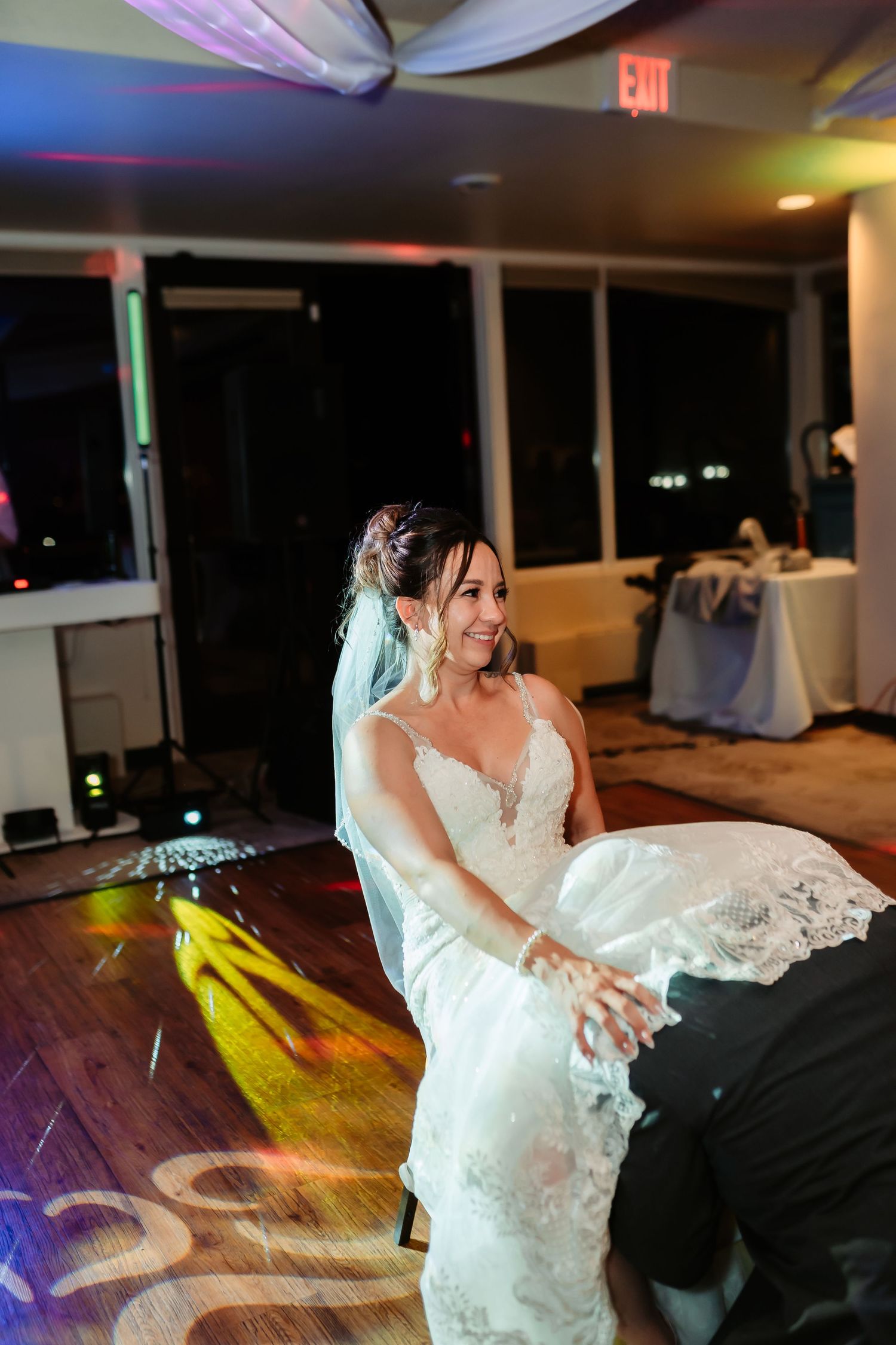 Wedding dance sequence showing a couple performing an elegant dip move on a wooden dance floor.