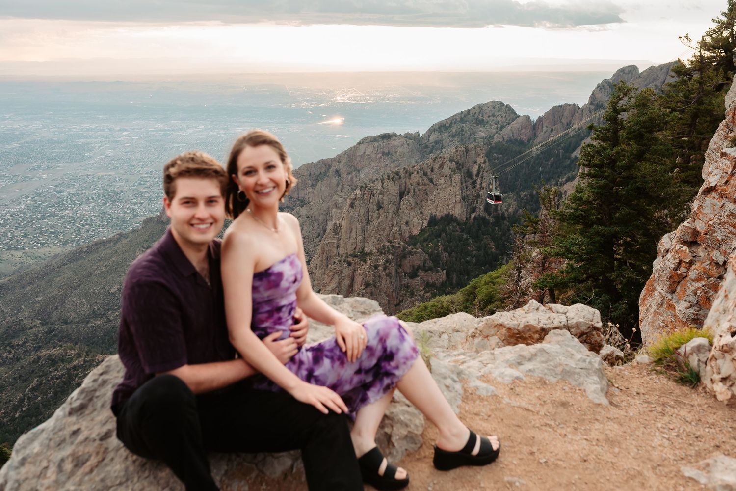 Engagement photoshoot on a scenic mountain overlook with expansive valley views.