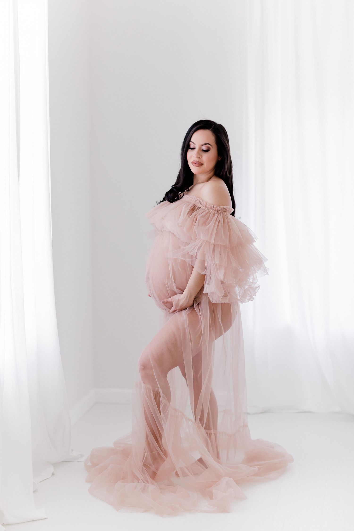 Soft and ethereal portrait with sheer blush pink gown in minimalist white space.