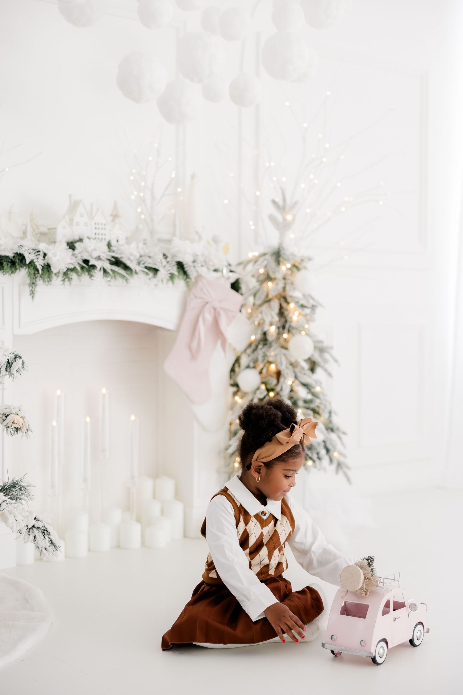 Elegant winter wonderland setup with white decor and evergreen accents.