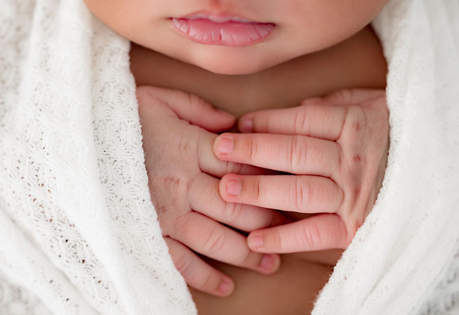 A series of close-up shots showing soft baby hands against a white background.
