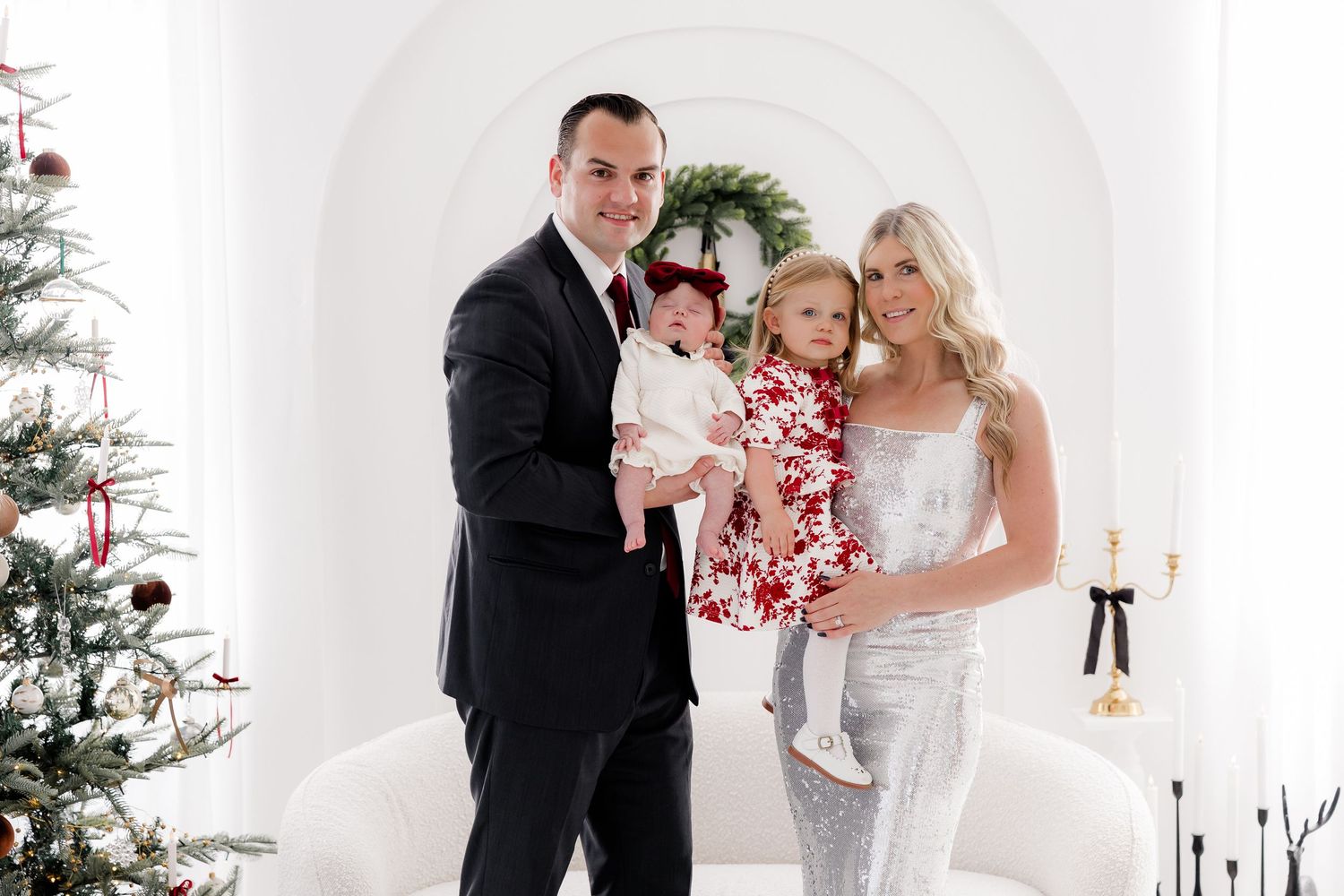 Festive holiday studio with white walls, hanging wreaths, and decorative Christmas elements.