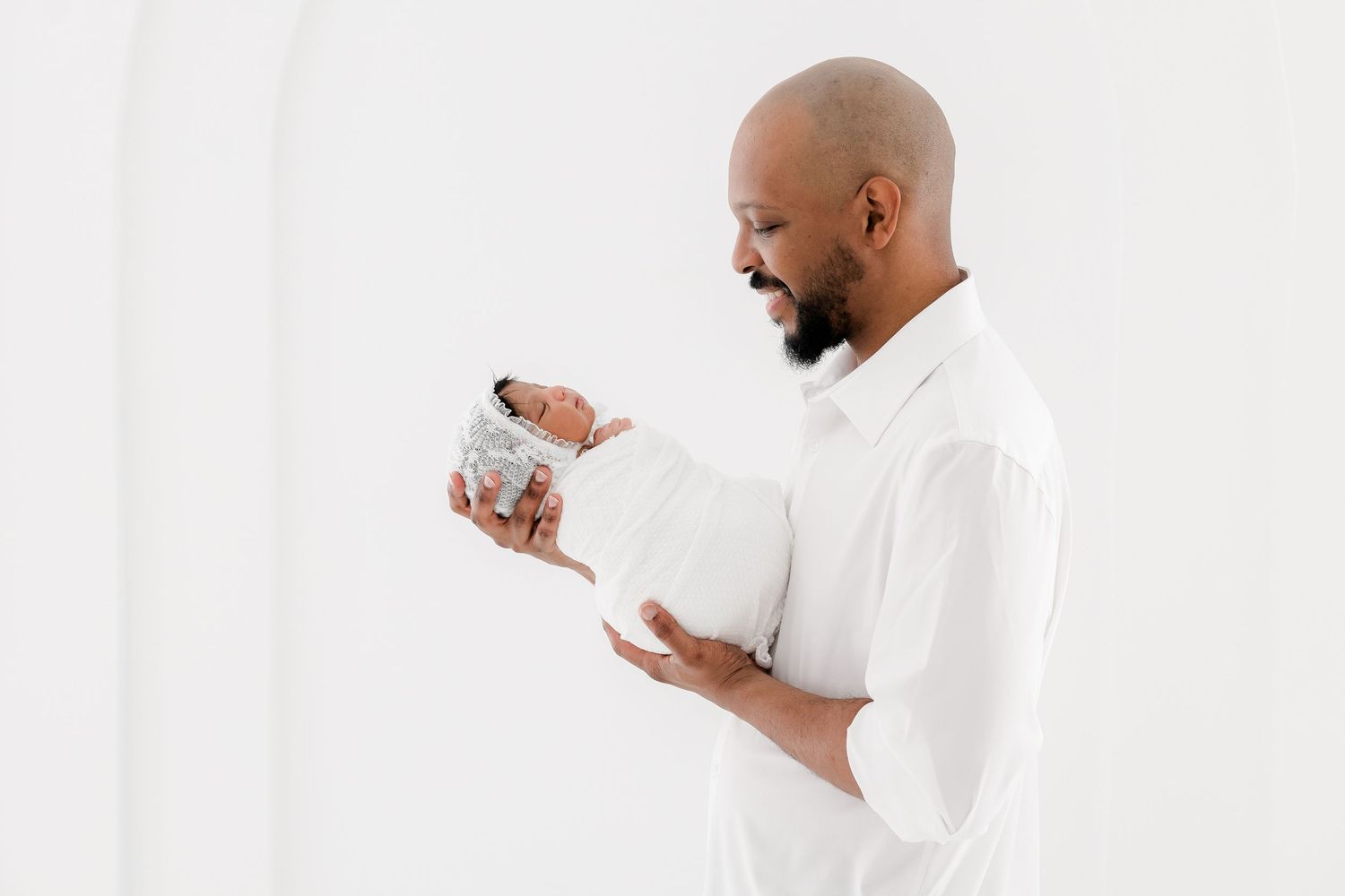 Man in white shirt against white background shown in three poses looking at a mobile device.